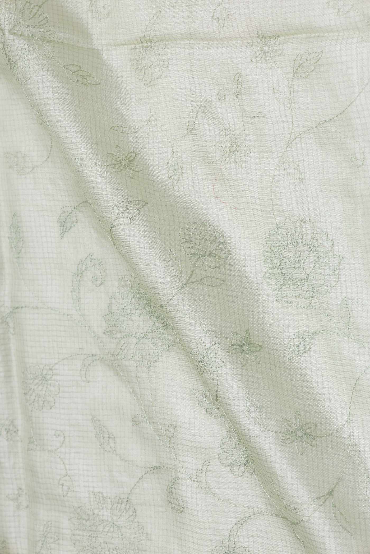 Close up of Pista Green Dual Tone Tussar Saree with Embroidery on the body and Embroidery Border displaying folds