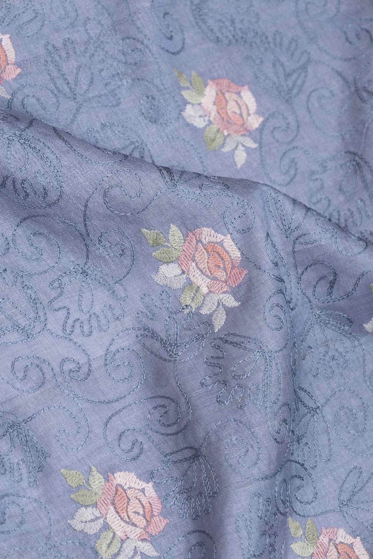 Close up of Blue Grey Tussar Silk Saree with Embroidery on the body and Embroidery Border displaying folds