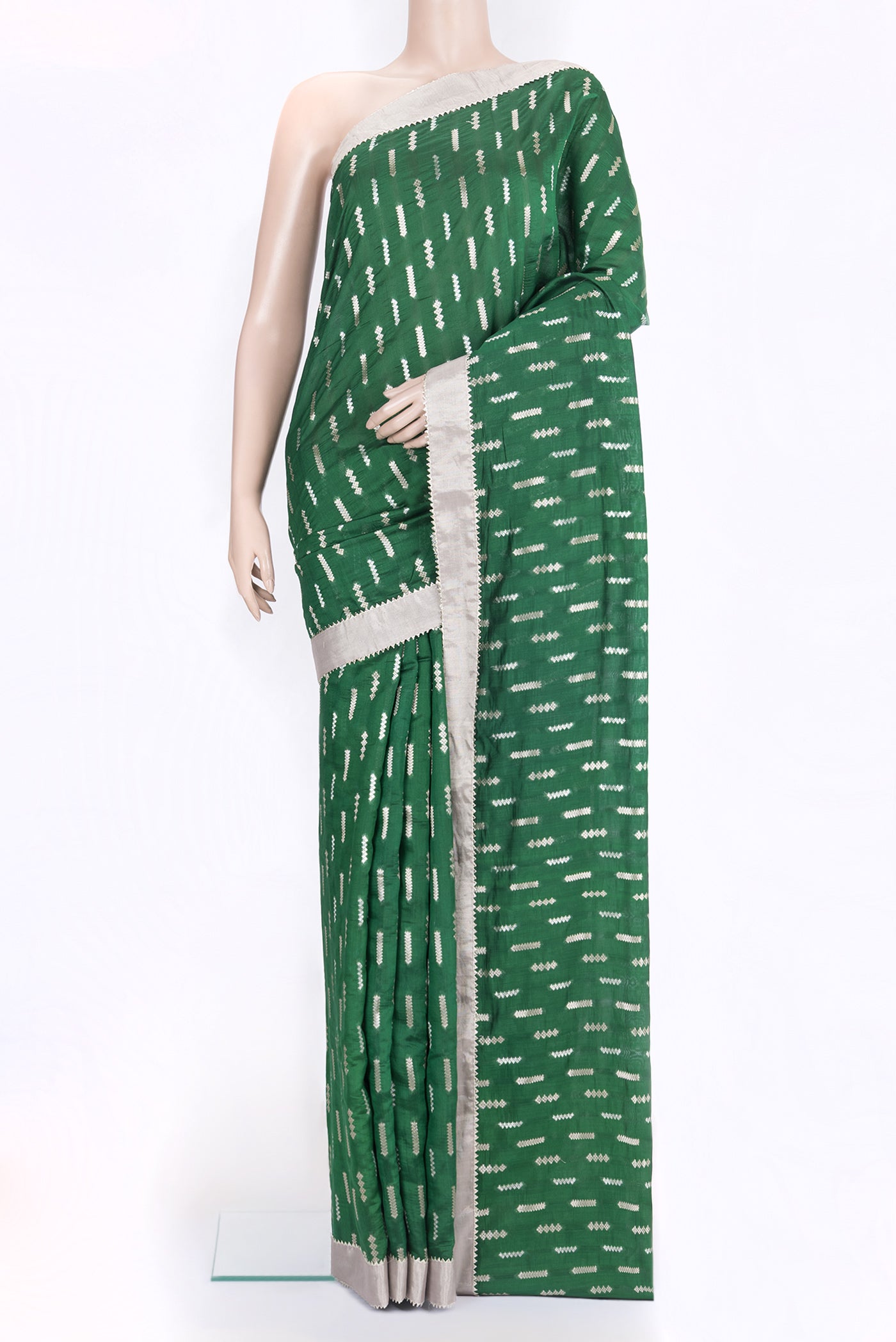 Bottle Green Tussar Silk Saree with Zari Butta on the body and Zari Border.  displayed on a mannequin