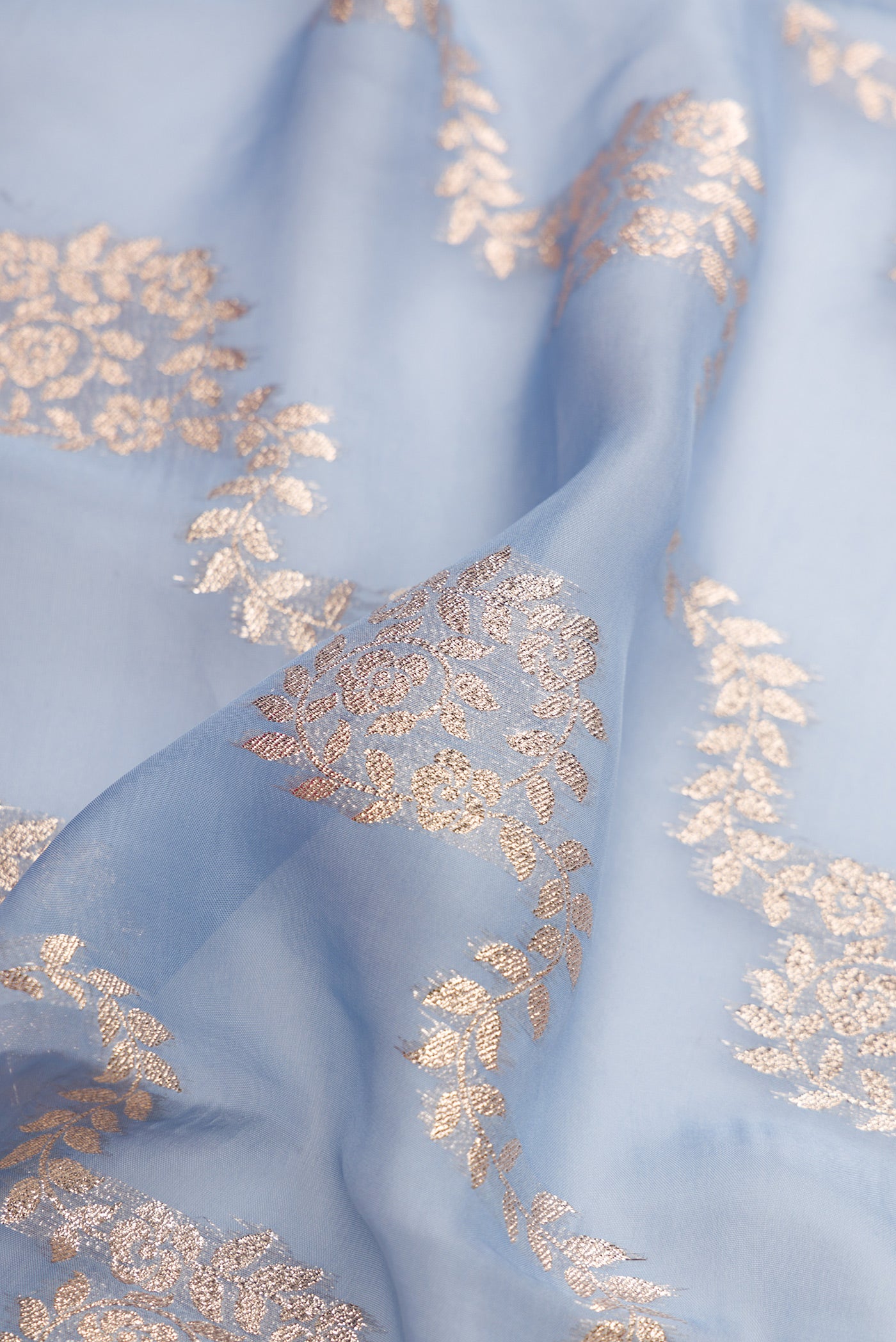 Close up of Maya Blue Dual Tone Organza Silk Saree with Stripes on the body and Embroidery Border.  displaying folds
