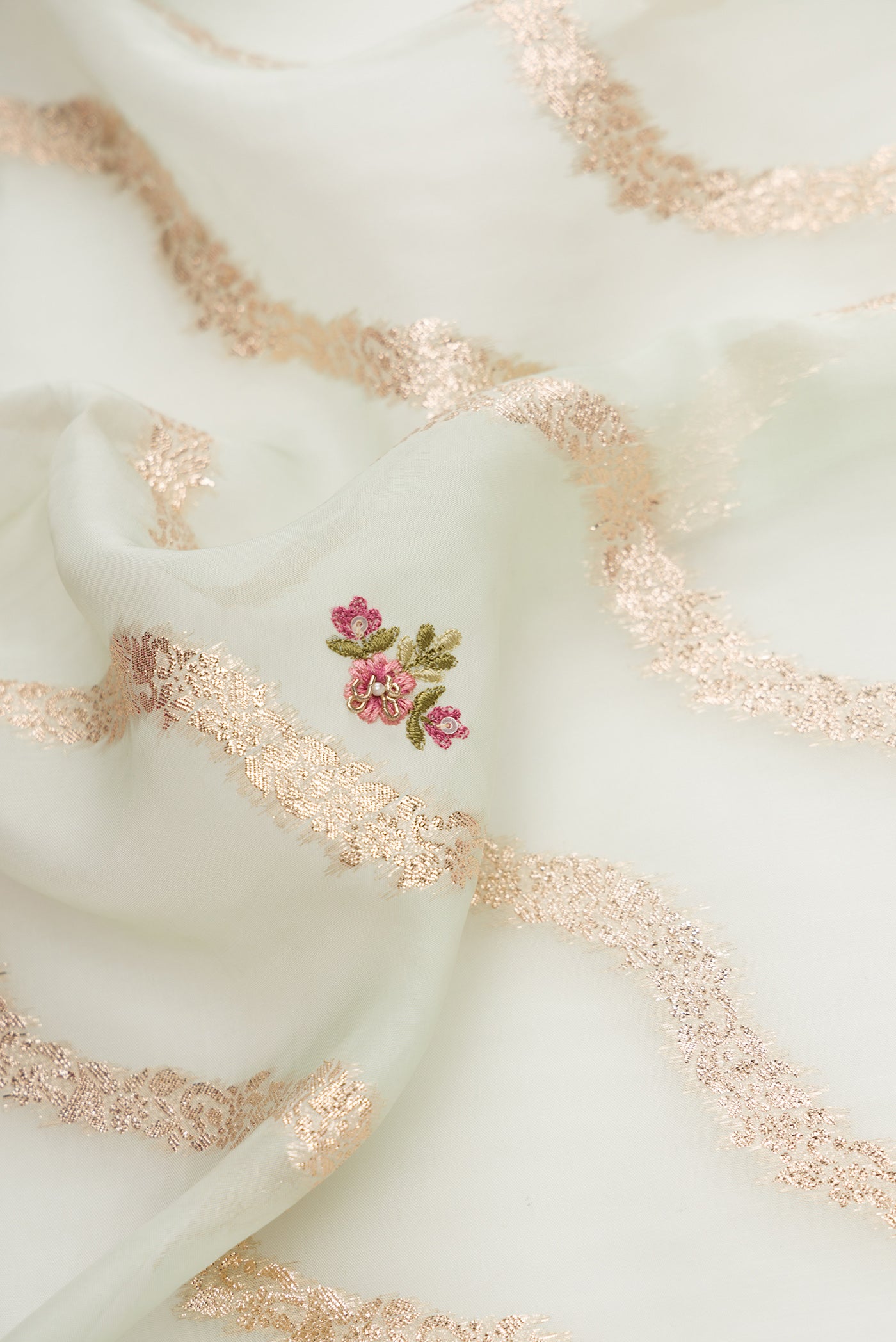 Close up of Pista Green Dual Tone Organza Silk Saree with Stripes on the body and Embroidery Border.  displaying folds