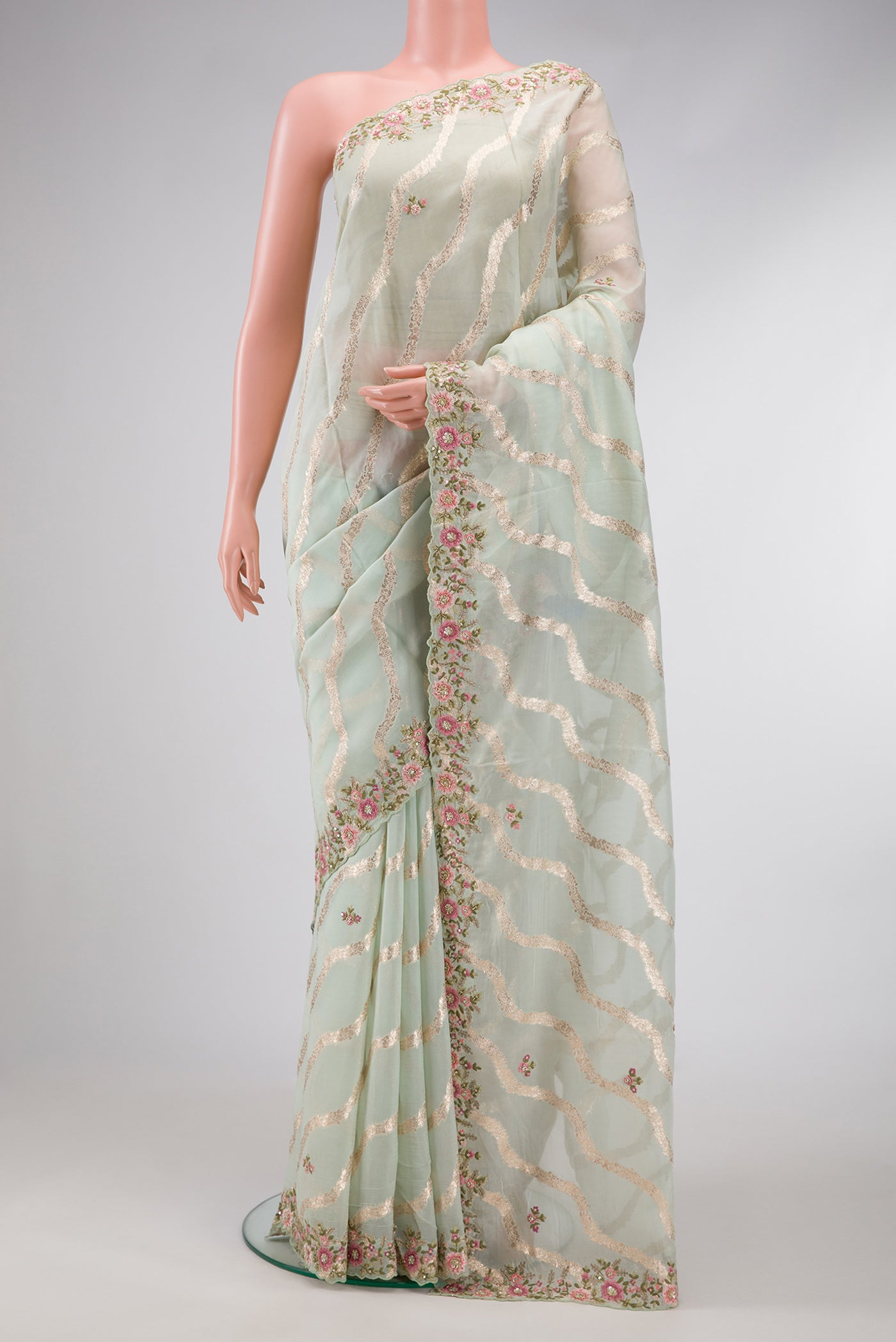 Pista Green Dual Tone Organza Silk Saree with Stripes on the body and Embroidery Border.  displayed on a mannequin