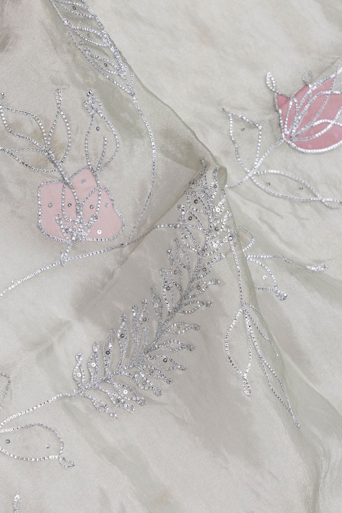 Close up of Pista Green Dual Tone Organza Silk Saree with Embroidery on the body and Embroidery Border.  displaying folds