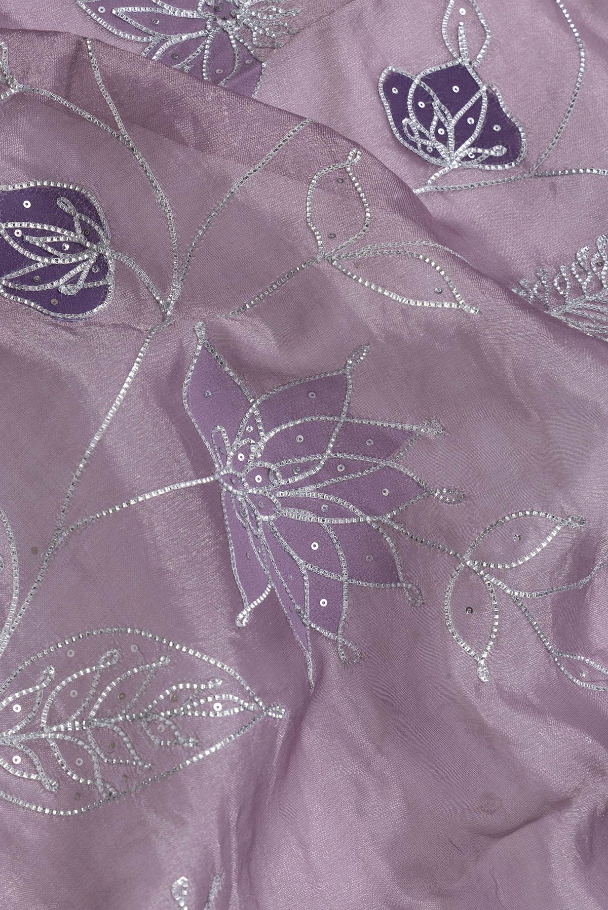 Close up of Lavender Dual Tone Organza Silk Saree with Embroidery on the body and Embroidery Border.  displaying folds