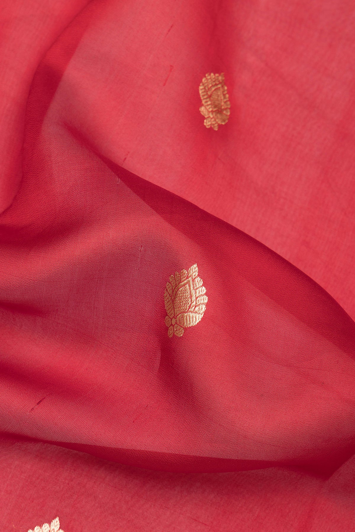 Close up of Pure Silk Red Dual Tone Tussar Saree with Zari Butta on the body and Fancy Border.  displaying folds
