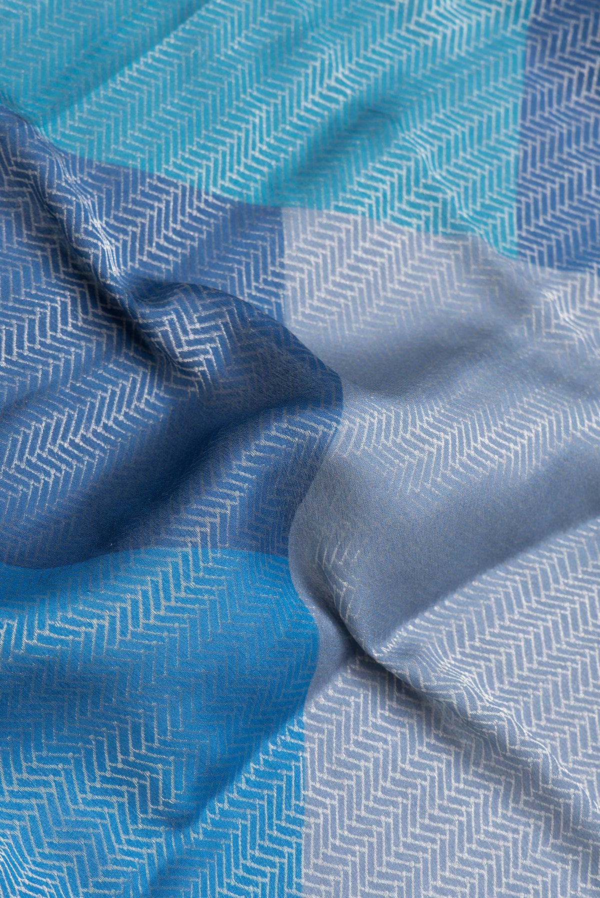 Close up of Navy Blue and Sky Blue Color Mysore Georgette Saree with Zari Brocade on the body and Zari Border.  displaying folds
