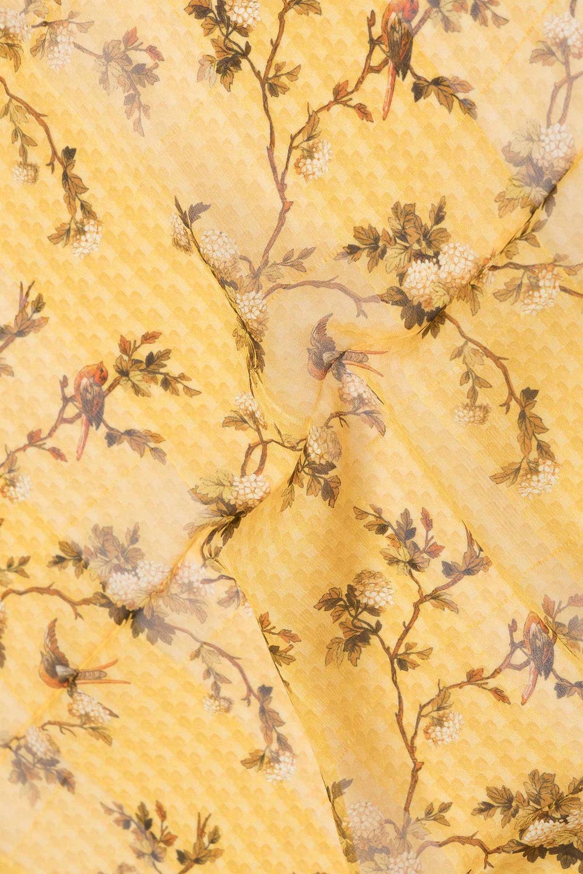 Close up of Yellow Dual Tone Mysore Chiffon Saree with Printed design on the body and Zari Border displaying folds