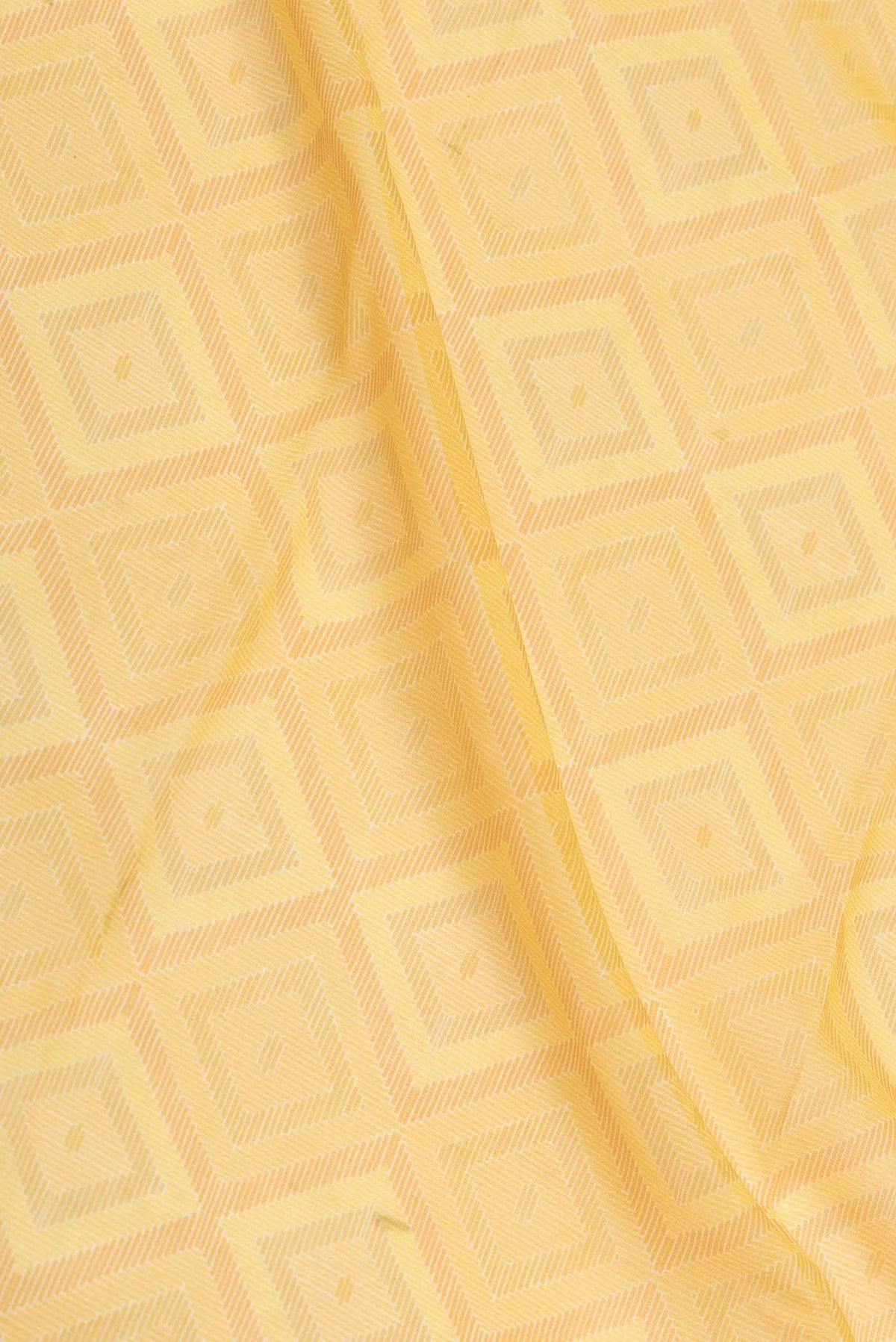 Close up of Yellow Dual Tone Georgette Saree with Printed design on the body and Zari Border displaying folds