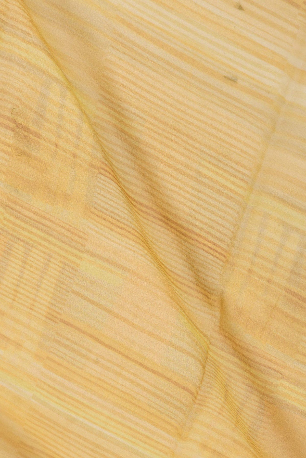 Close up of Yellow Dual Tone Georgette Saree with Printed design on the body and Zari Border displaying folds