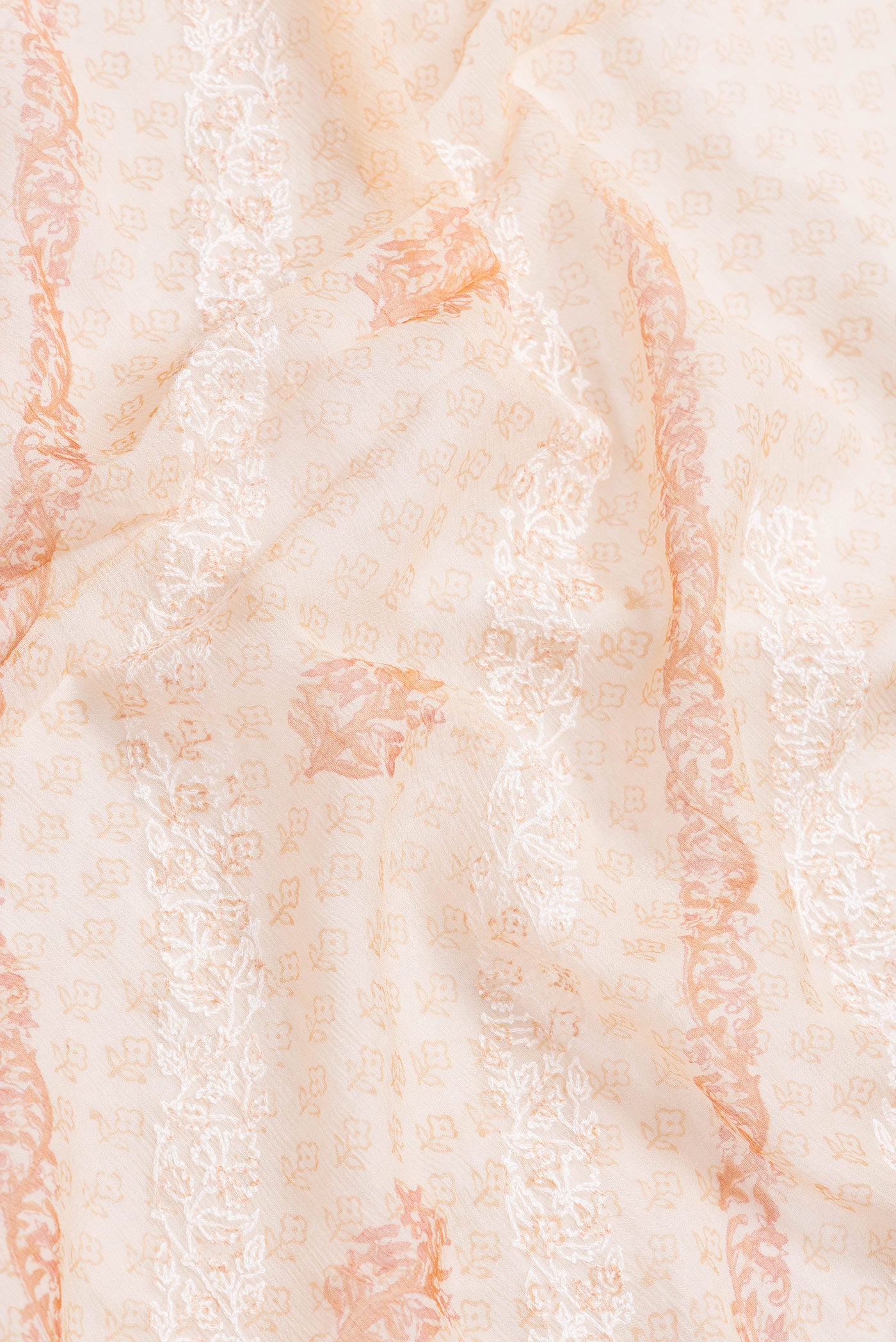Close up of Golden Peach Dual Tone Mysore Chiffon Saree with Printed design on the body and Zari Border.  displaying folds