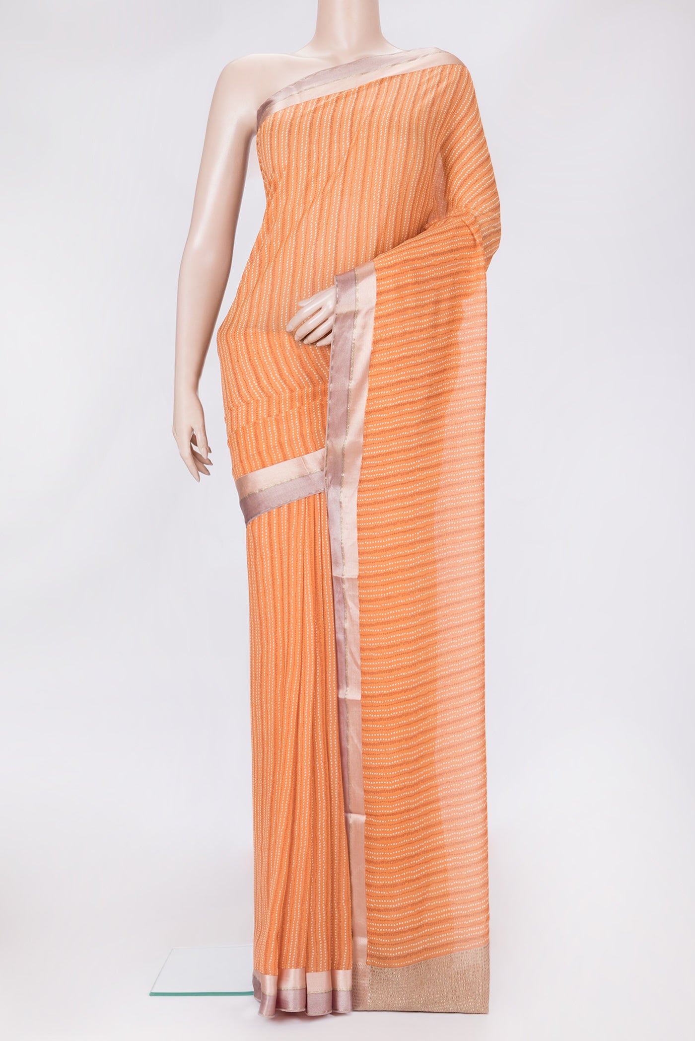 Peach Dual Tone Chiffon Saree with Printed design on the body and Zari Border.  displayed on a mannequin
