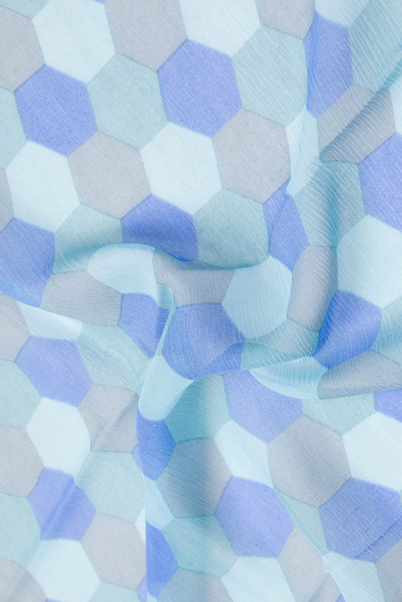 Close up of Sky Blue Dual Tone Mysore Chiffon Saree with Printed design on the body and Satin Border.  displaying folds