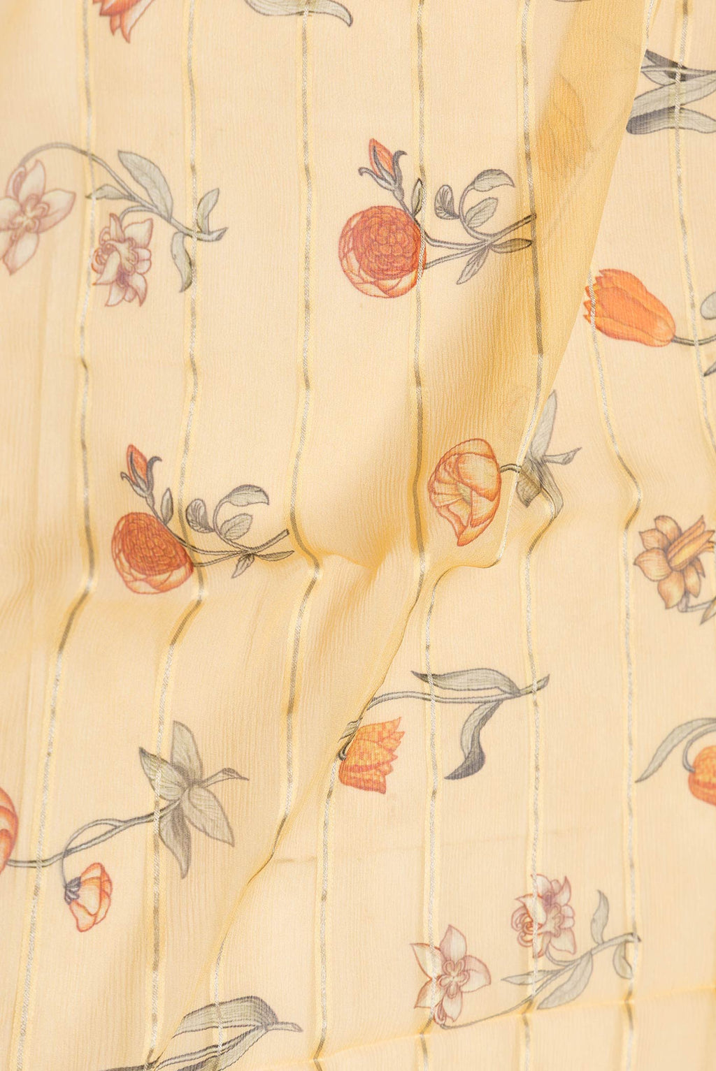 Close up of Yellow Dual Tone Mysore Chiffon Saree with Printed design on the body and Zari Border displaying folds