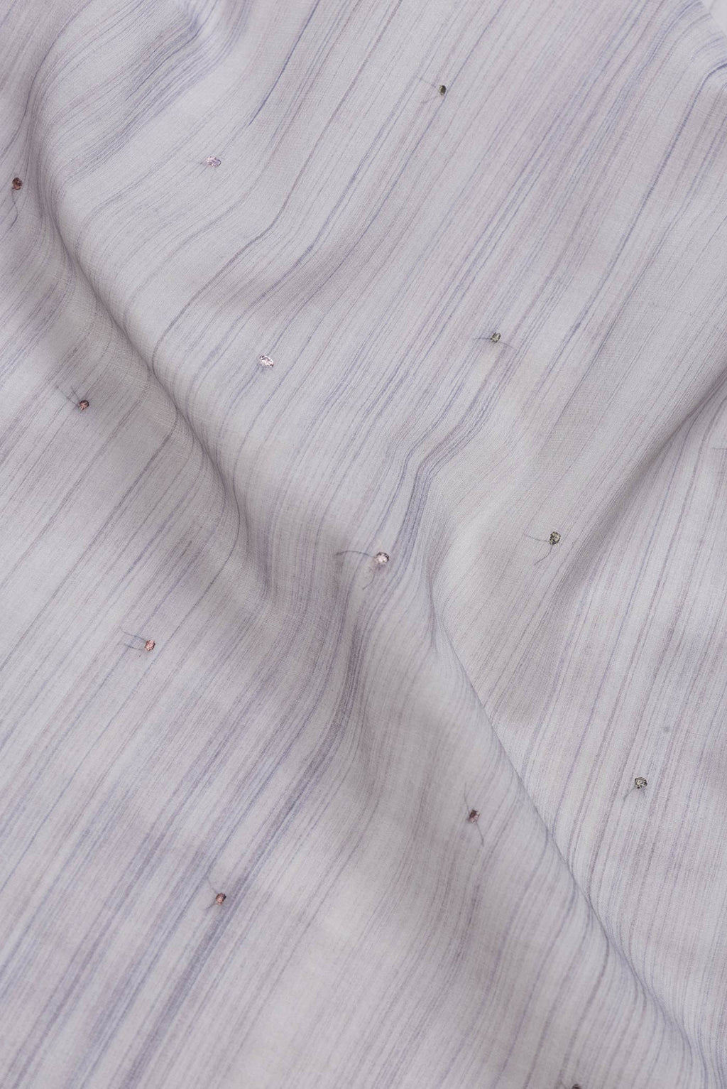 Close up of Grey Dual Tone Georgette Saree with Embroidery on the body and Embroidery Border.  displaying folds