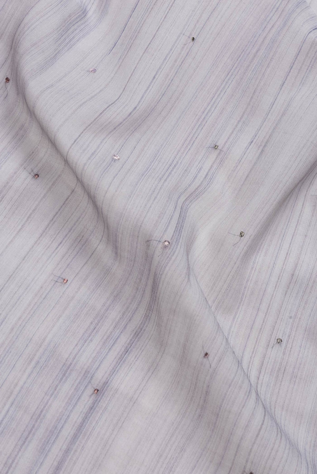 Close up of Grey Dual Tone Georgette Saree with Embroidery on the body and Embroidery Border.  displaying folds