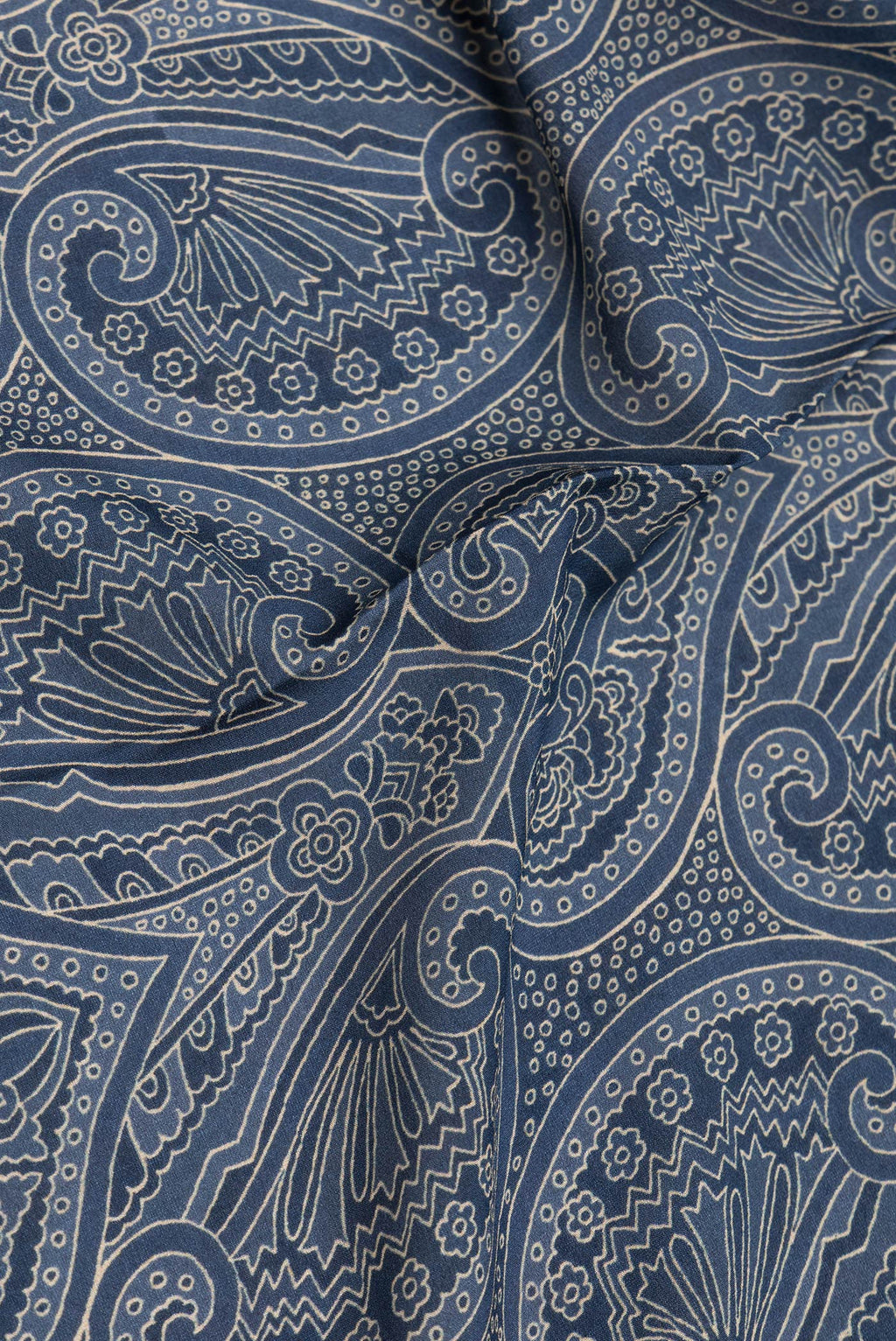 Close up of Grey Mysore Crepe Saree with Printed design on the body and Zari Border.  displaying folds