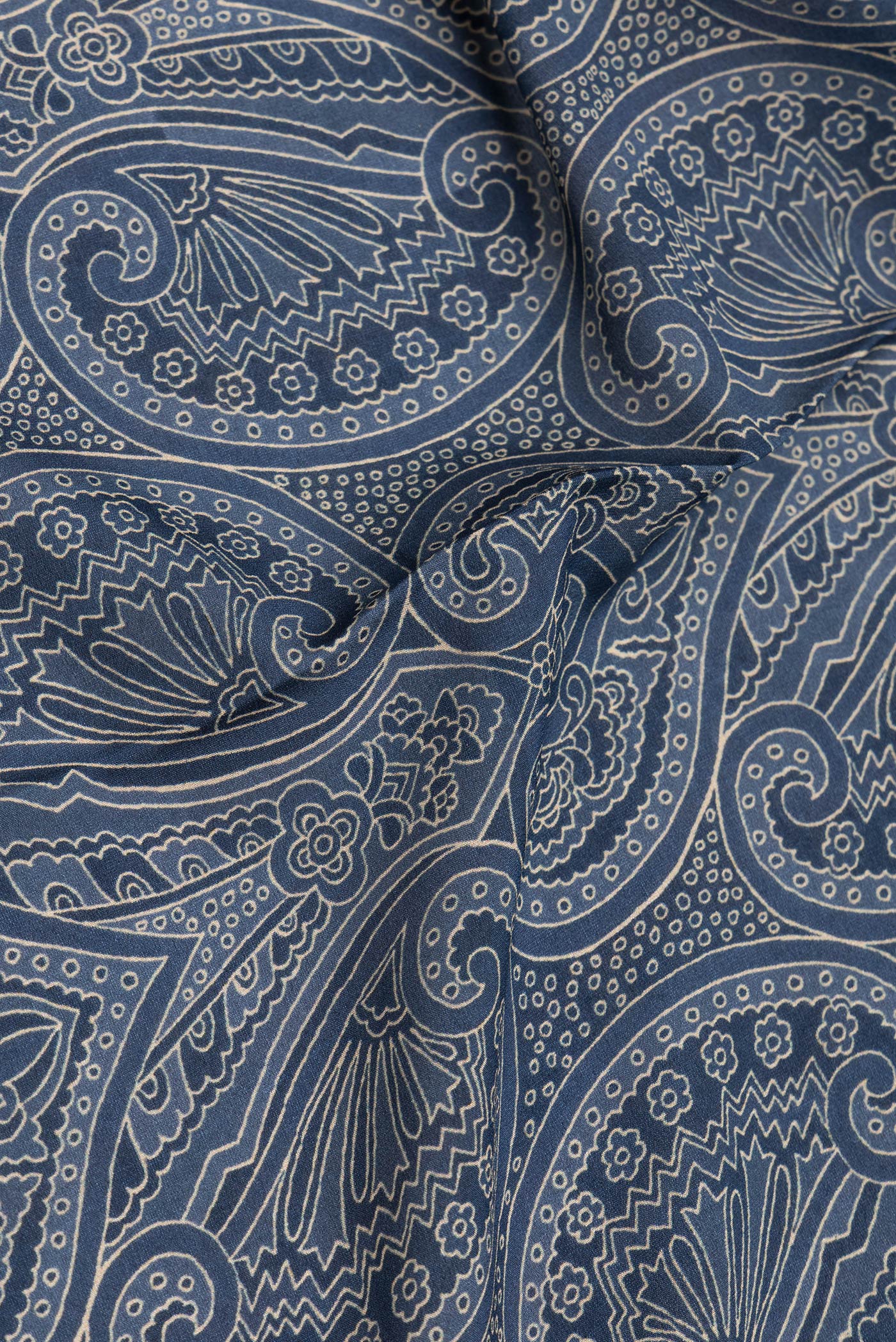 Close up of Grey Mysore Crepe Saree with Printed design on the body and Zari Border.  displaying folds