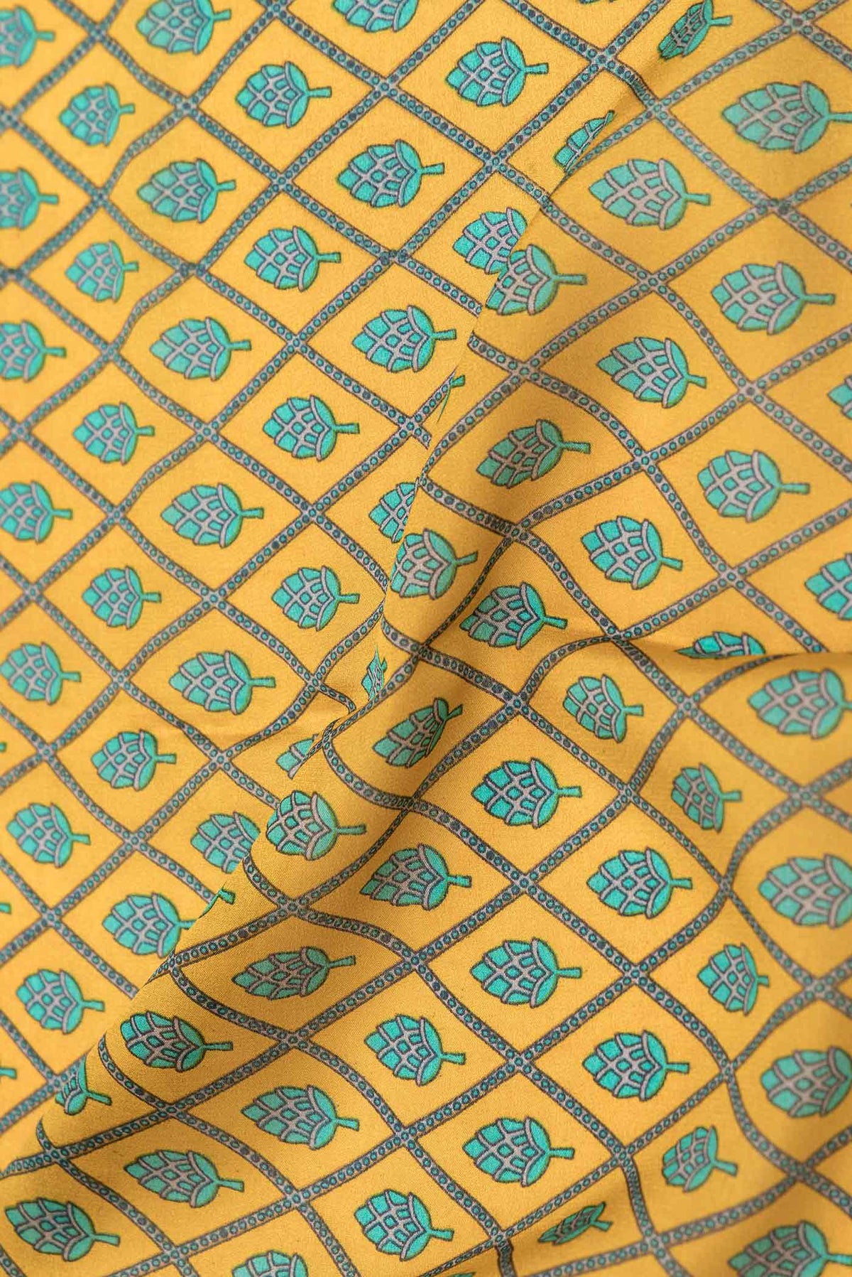 Close up of Mustard Dual Tone Mysore Crepe Saree with Printed design on the body and Zari Border displaying folds