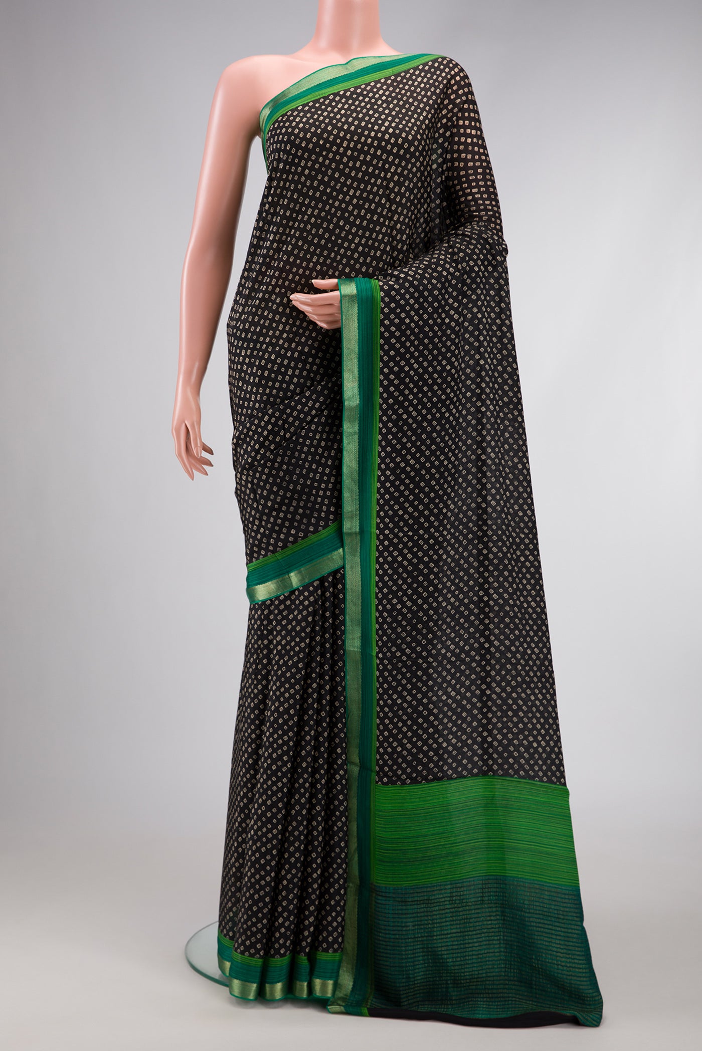 Black Dual Tone Mysore Crepe Saree with Bandhani Print on the body and Zari Border.  displayed on a mannequin