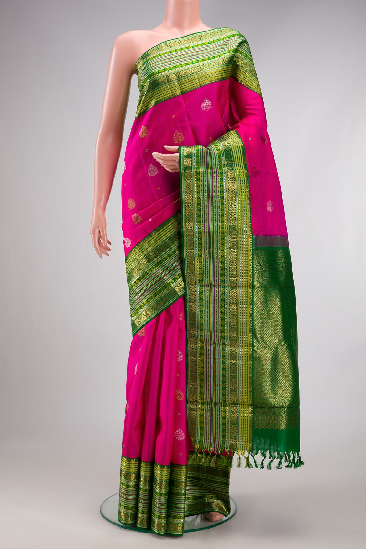 Pure Silk Pure Zari Rani Pink Kanchipuram Saree with Zari Butta on the body and Zari Border.  displayed on a mannequin
