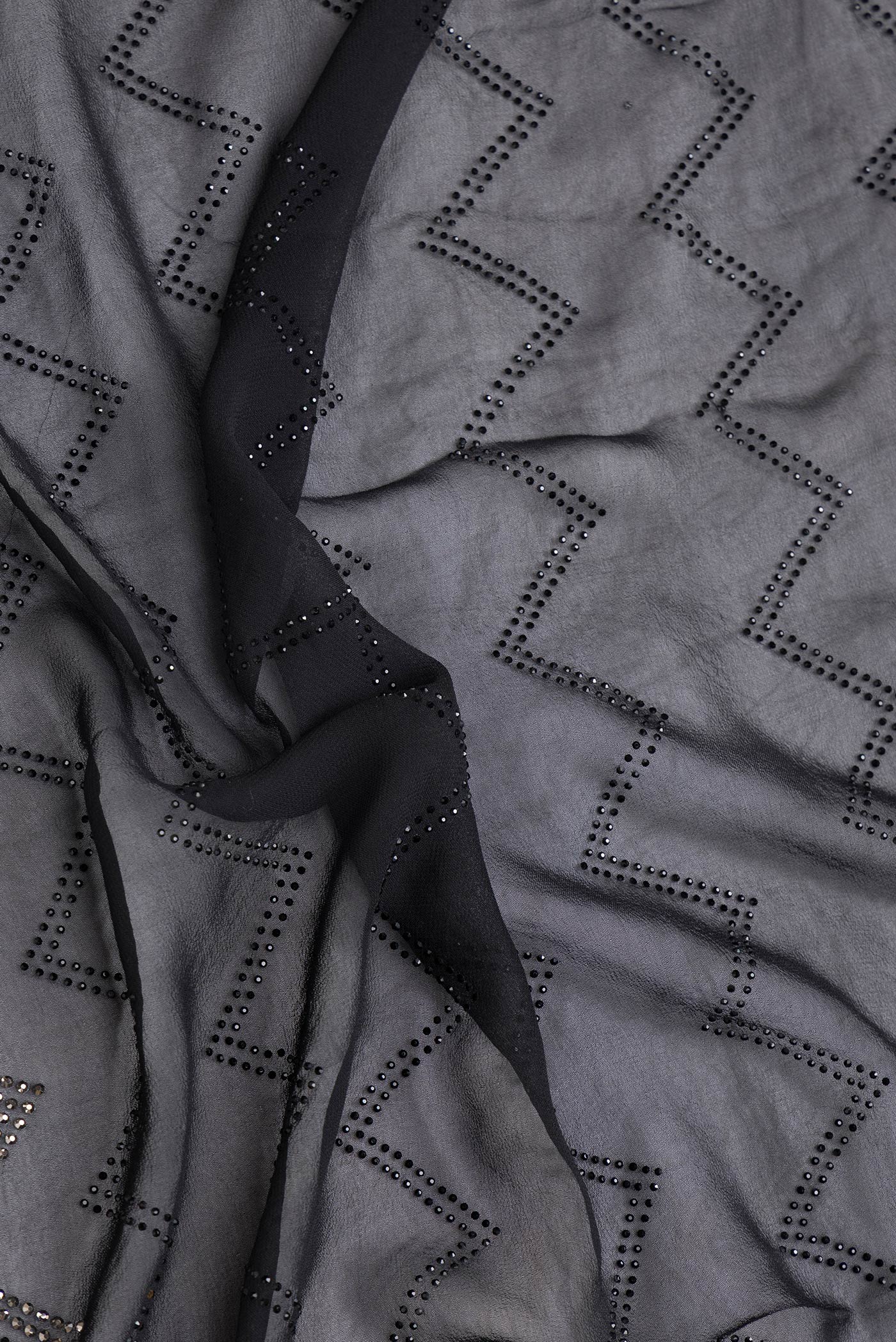 Close up of Black Dual Tone Mysore Georgette Saree with Embroidery on the body and Embroidery Border.  displaying folds