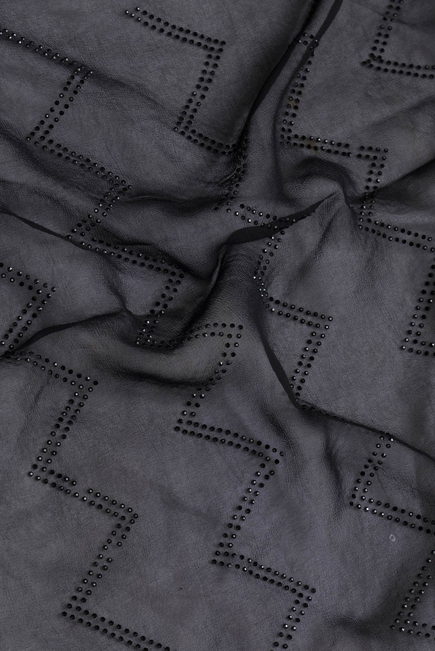 Close up of Black Dual Tone Georgette Saree with Embroidery on the body and Embroidery Border.  displaying folds