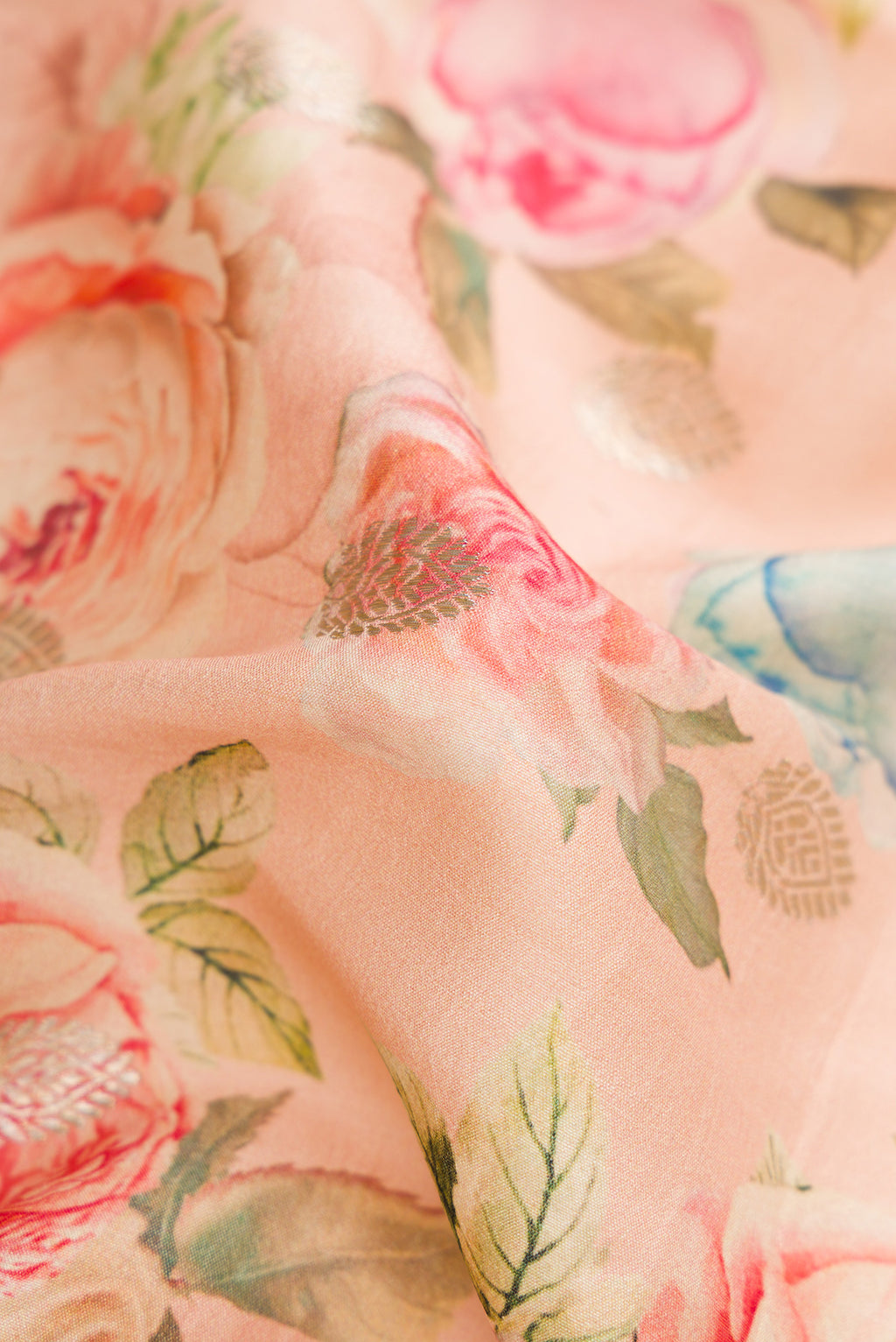 Close up of Peach Dual Tone Tussar Silk Saree with Printed design on the body and Zari Border.  displaying folds