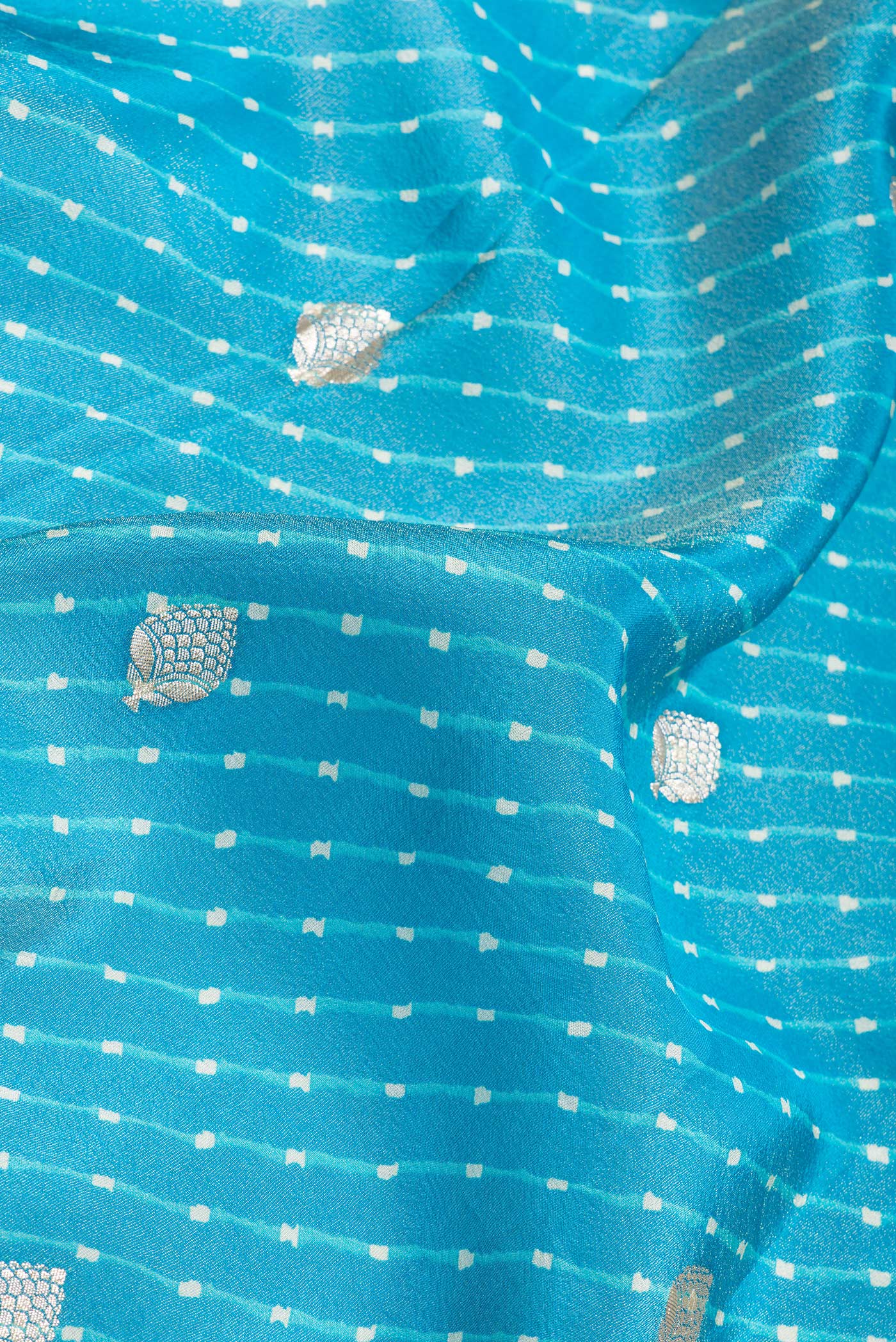 Close up of Sky Blue Dual Tone Organza Silk Saree with Embroidery on the body and Embroidery Border.  displaying folds