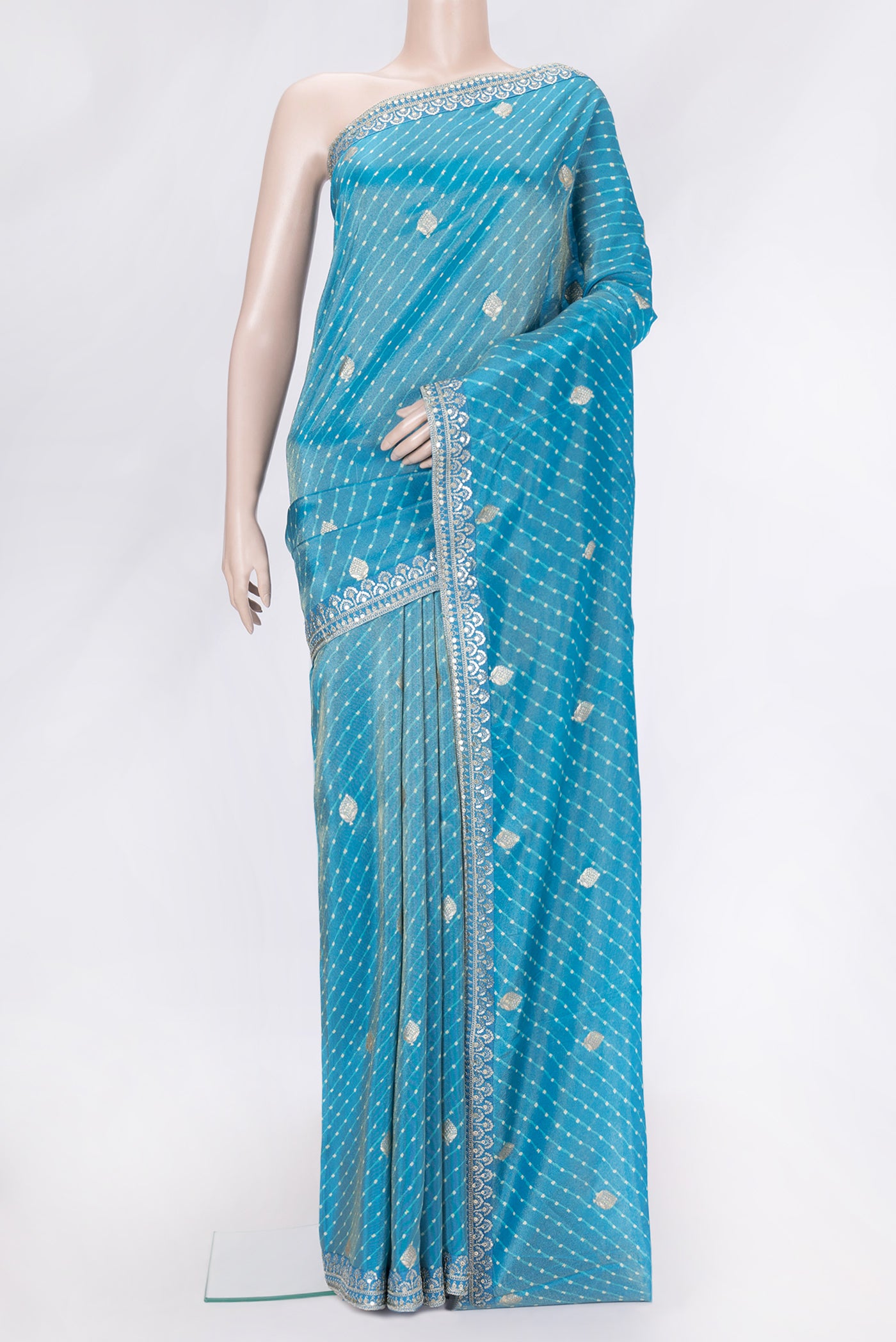 Sky Blue Dual Tone Organza Silk Saree with Embroidery on the body and Embroidery Border.  displayed on a mannequin