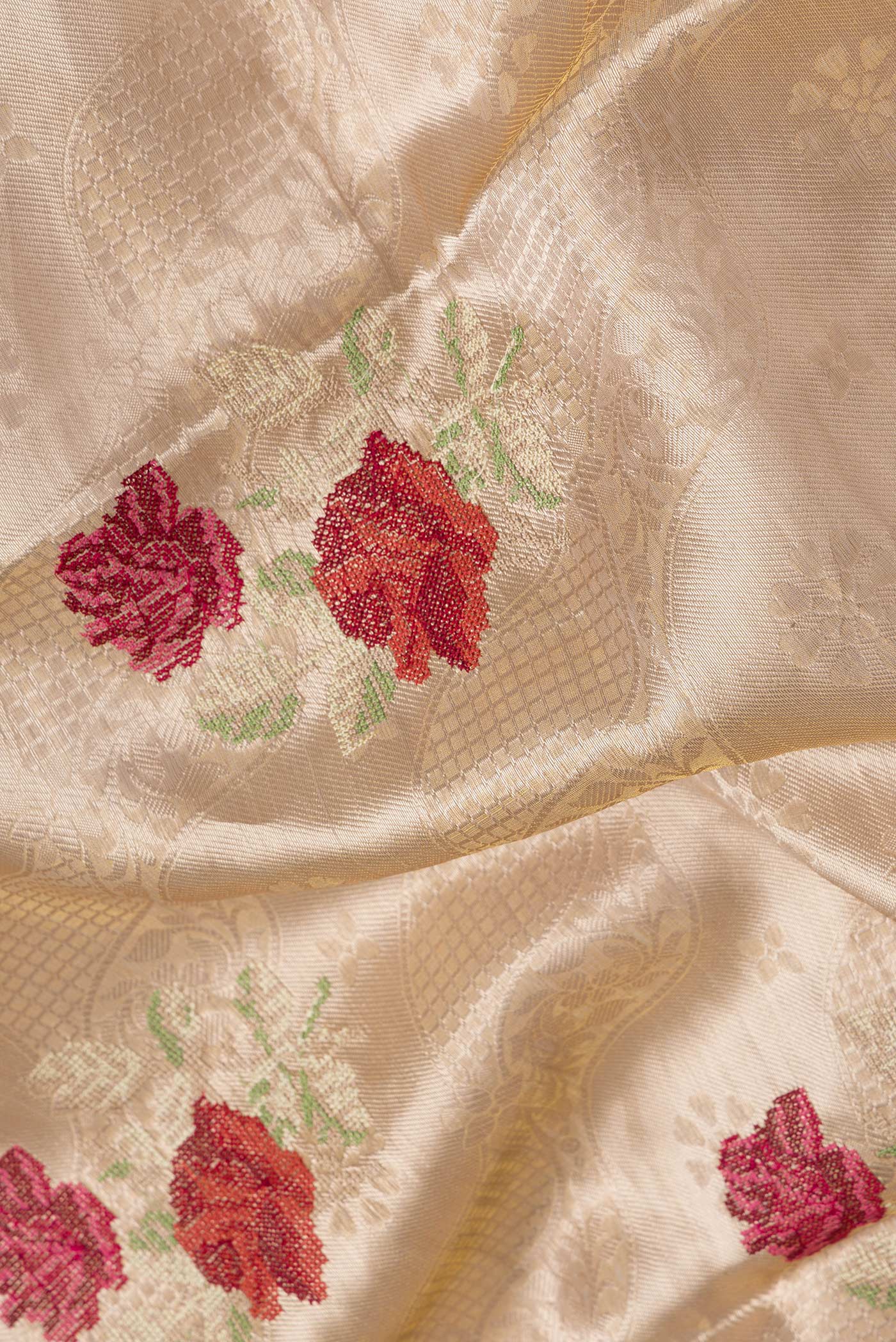 Close up of Gold Dual Tone Organza Silk Saree with Zari Brocade on the body and Zari Border.  displaying folds