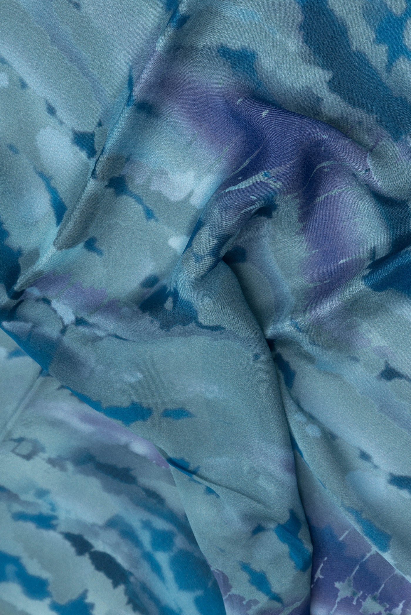 Close up of Grey Dual Tone Crepe Saree with Printed design on the body and Without Border.  displaying folds