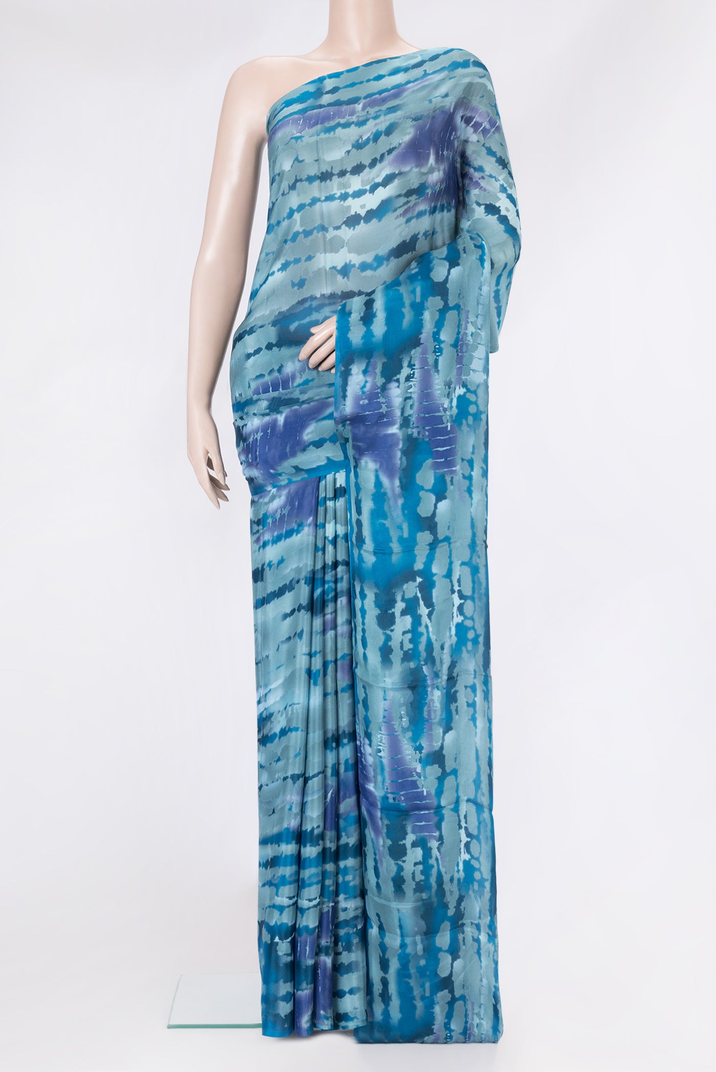 Grey Dual Tone Crepe Saree with Printed design on the body and Without Border.  displayed on a mannequin