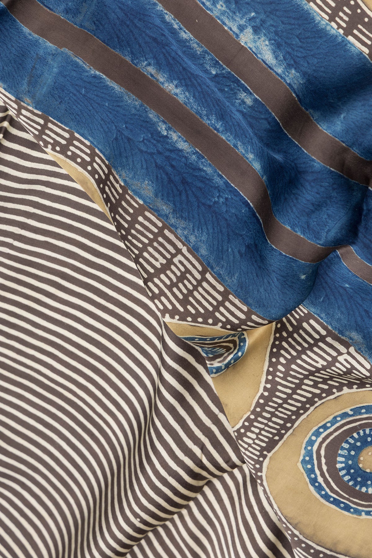 Close up of Brown Dual Tone Blended Crepe Saree with Printed design on the body and Without Border.  displaying folds