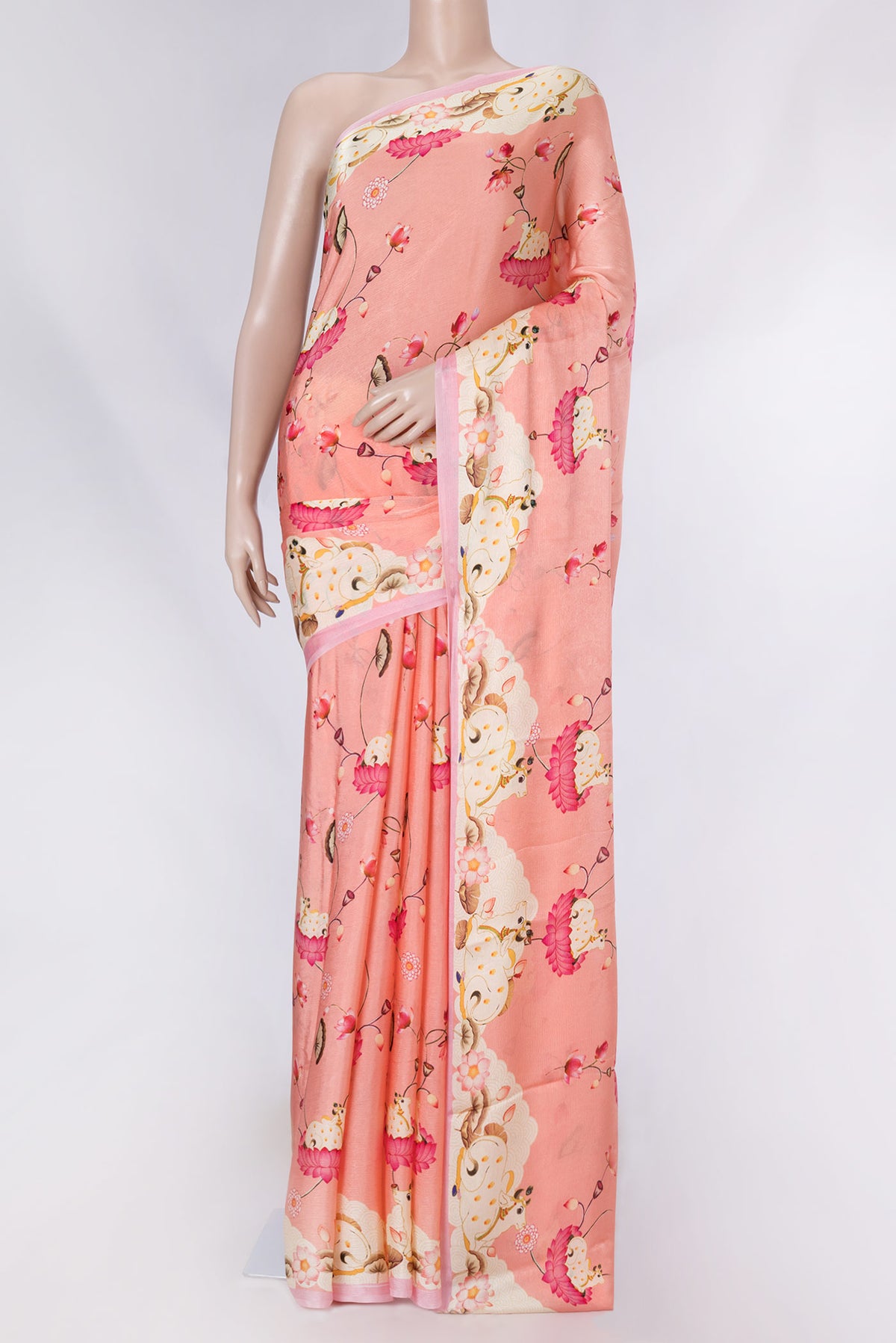 Peach Dual Tone Mysore Crepe Saree with Printed design on the body and Printed Border displayed on a mannequin