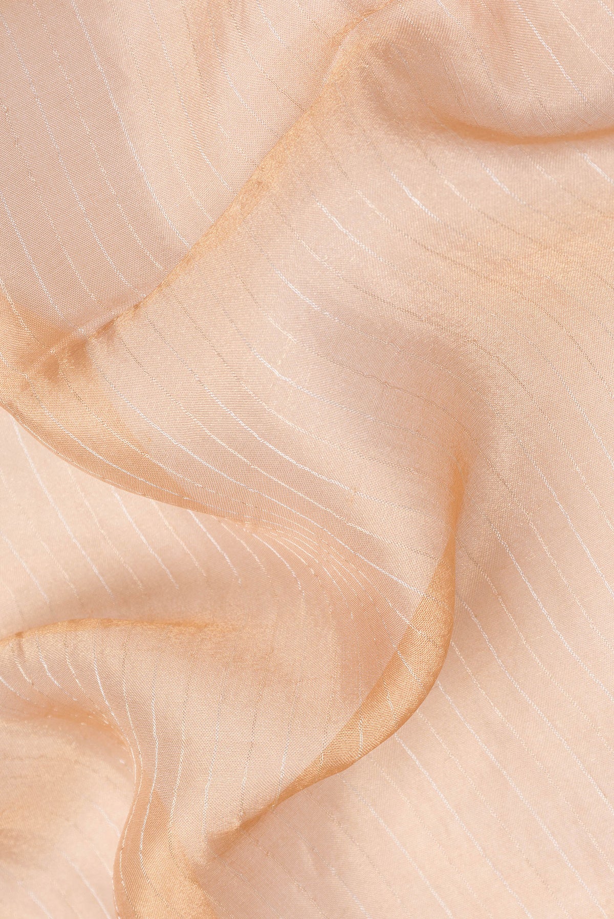 Close up of Golden Peach Dual Tone Organza Silk Saree with Stripes on the body and Embroidery Border.  displaying folds
