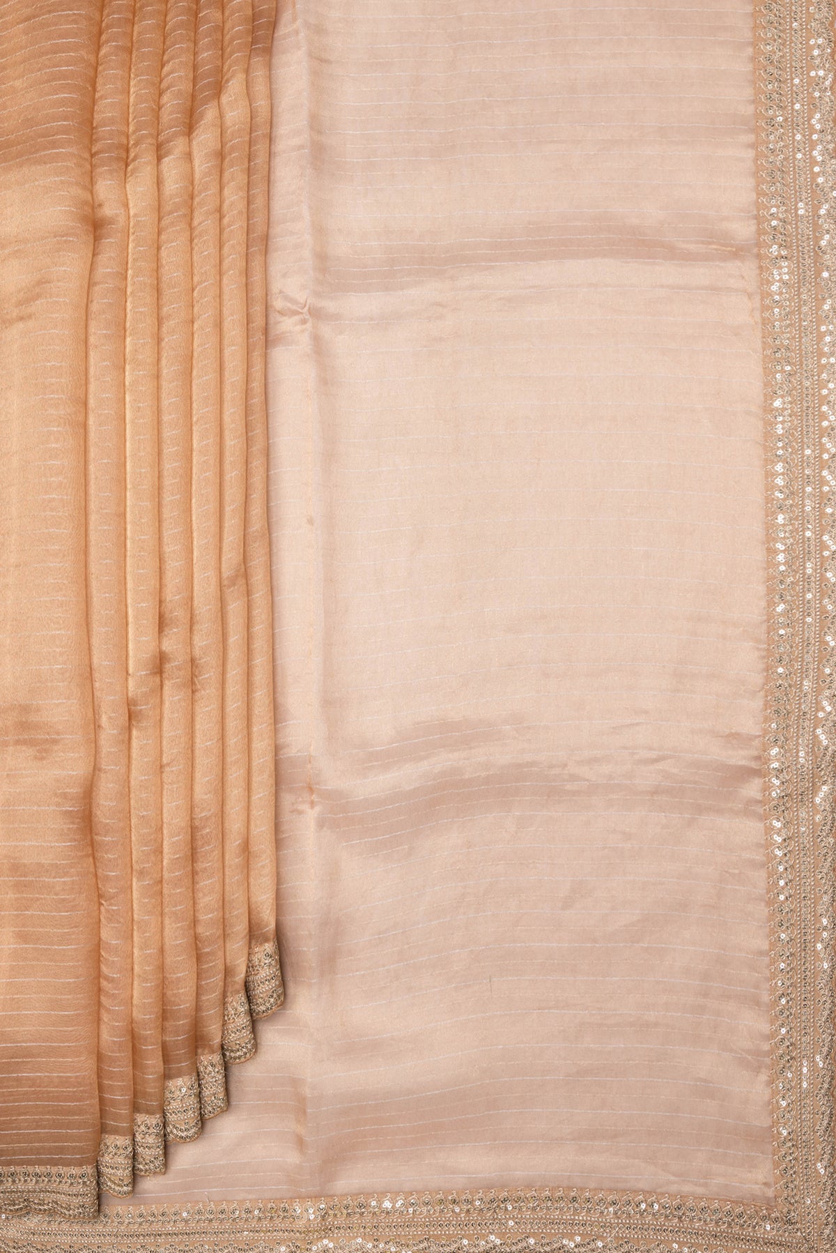 Pleats and pallu of Golden Peach Dual Tone Organza Silk Saree with Stripes on the body and Embroidery Border. 