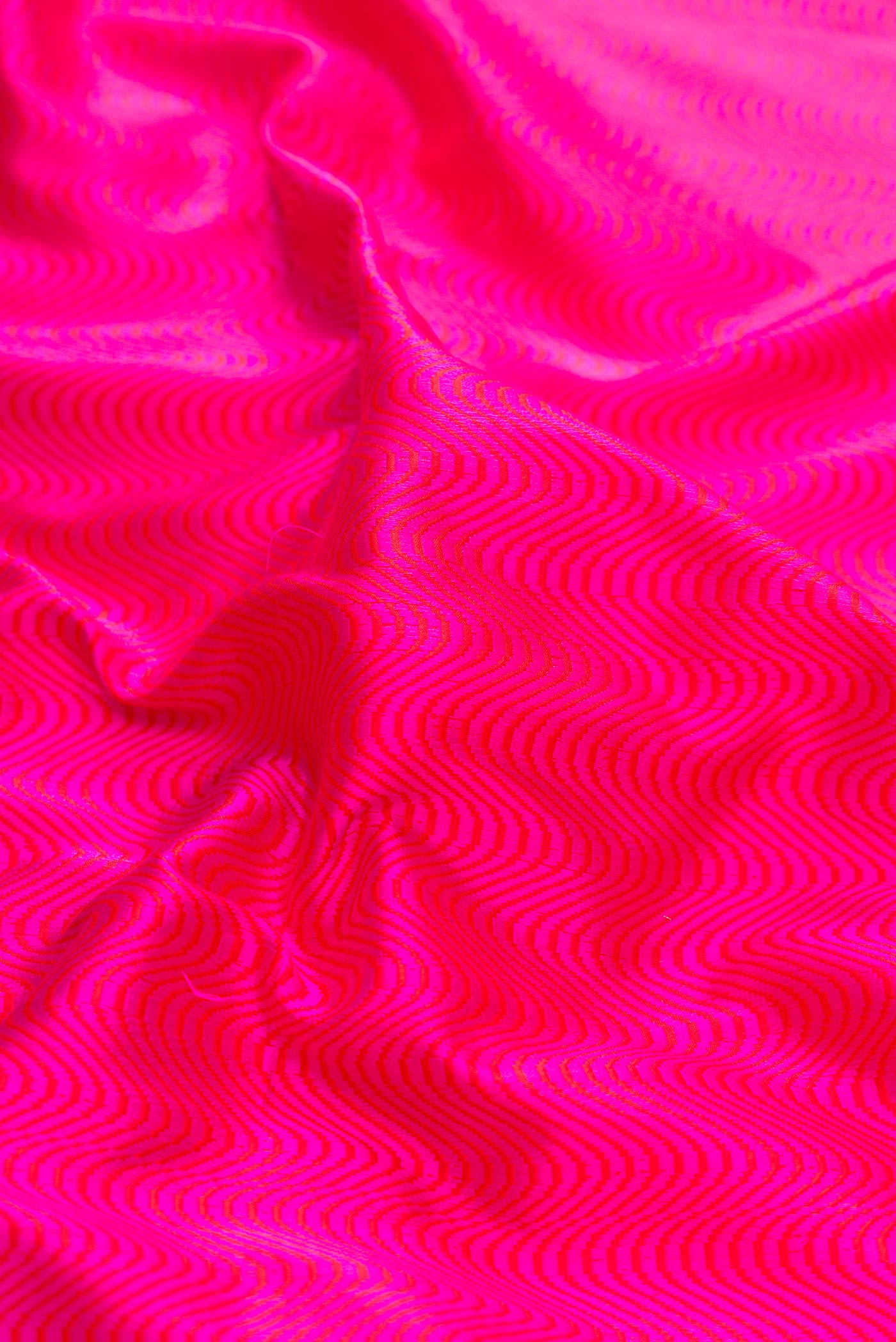 Close up of Pure Silk Pure Zari Pink Dual Tone Banarasi Saree with Jacquard design on the body and Fancy Border displaying folds