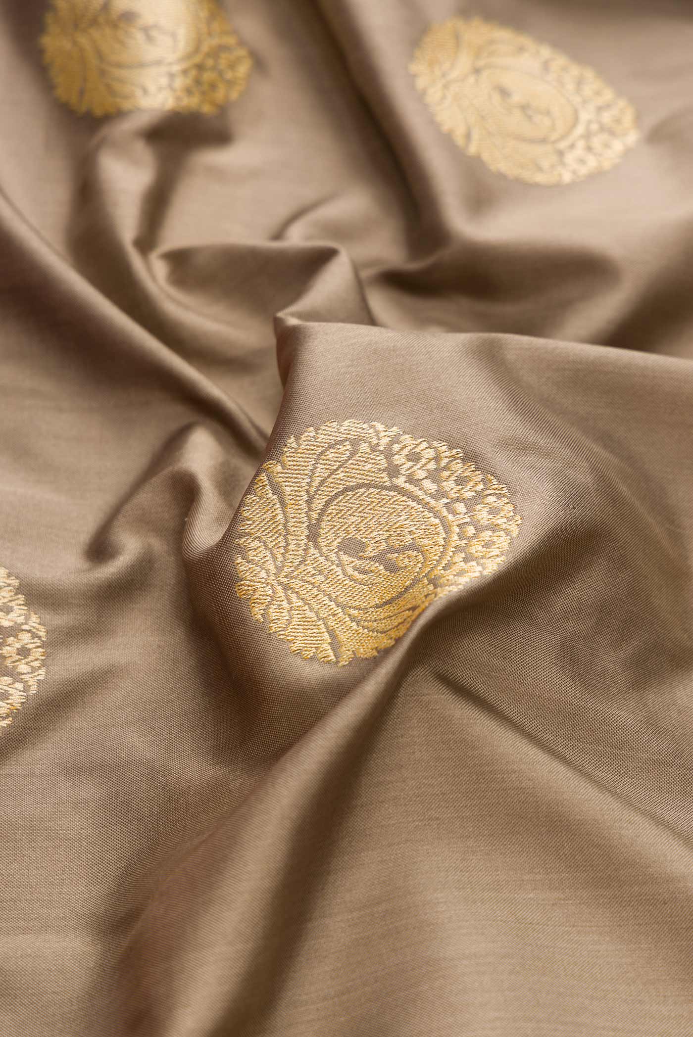 Close up of Pure Silk Pure Zari Grey Dual Tone Banarasi Saree with Zari Butta on the body and Fancy Border displaying folds