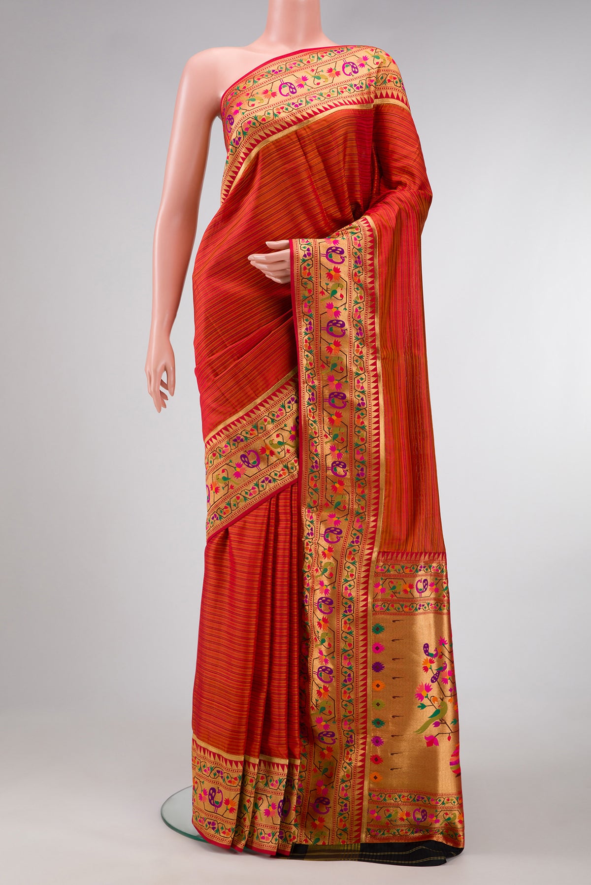 Red Dual Tone Rajkot Patola Silk Saree with Stripes on the body and Paithani Border.  displayed on a mannequin