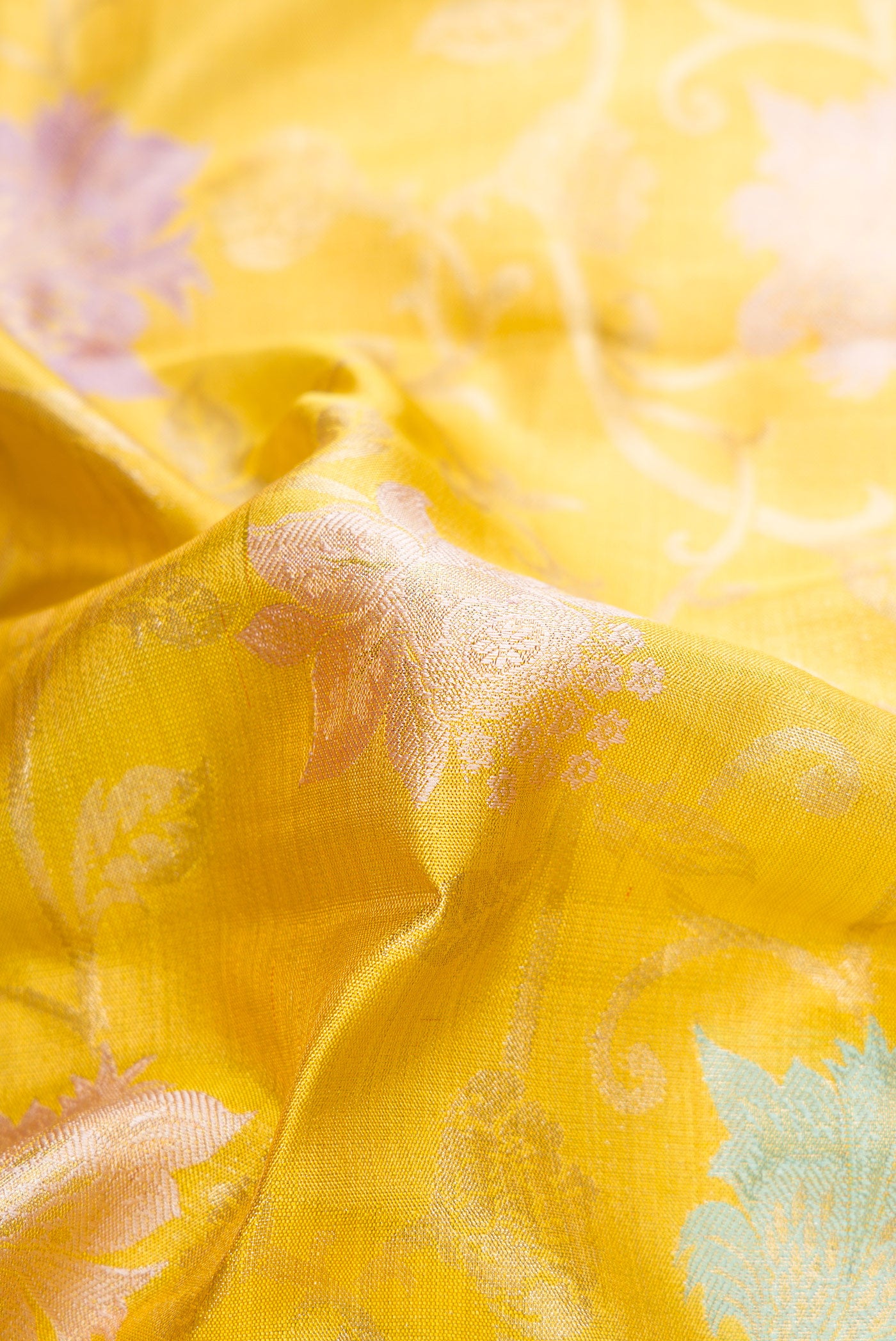 Close up of Gold Dual Tone Kanjivaram Tissue Silk Saree with Zari Brocade on the body and Zari Border.  displaying folds