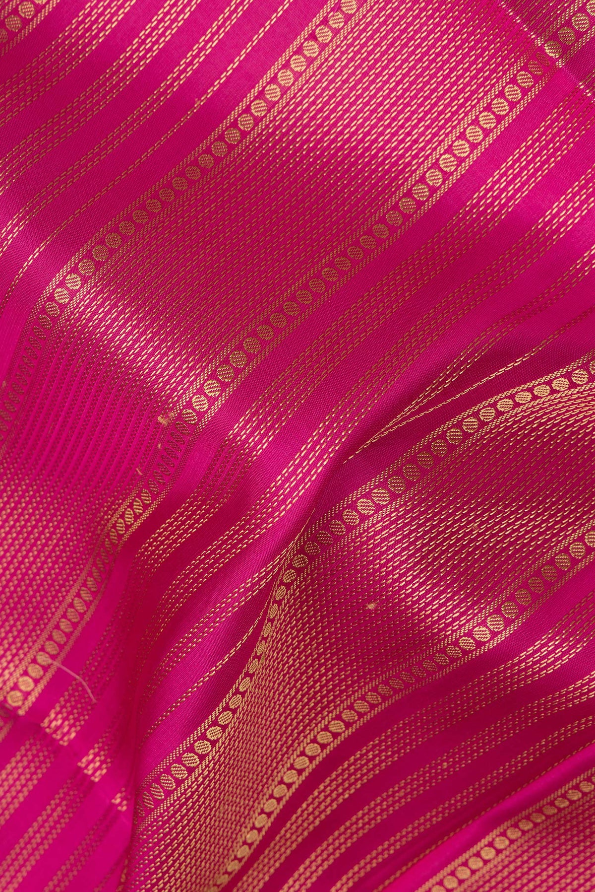 Close up of Pure Silk Pink Dual Tone Soft Saree with Thread Butta on the body and Thread Border.  displaying folds