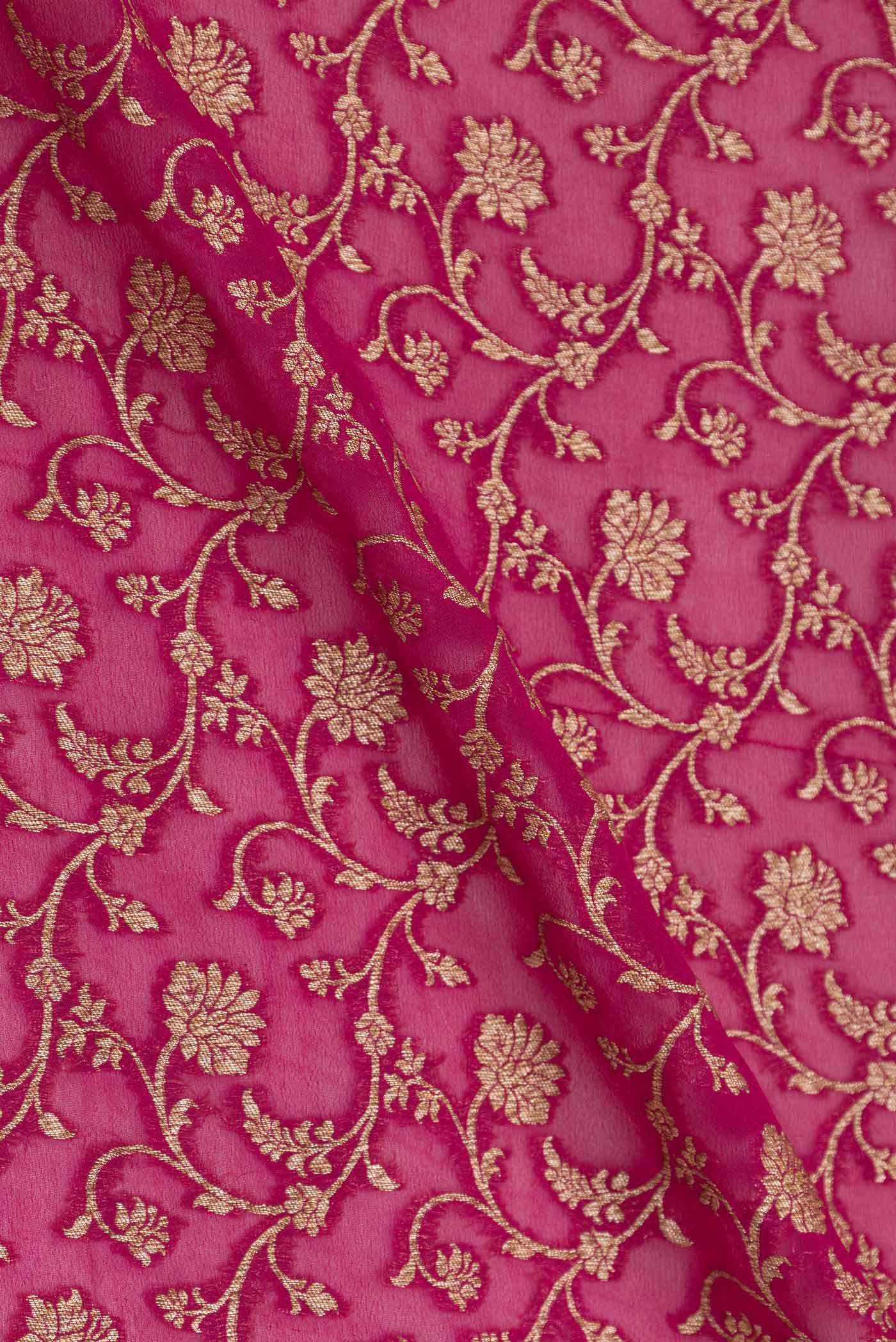 Close up of Dark Pink Banarasi Georgette Saree with Zari Brocade on the body and Zari Border displaying folds