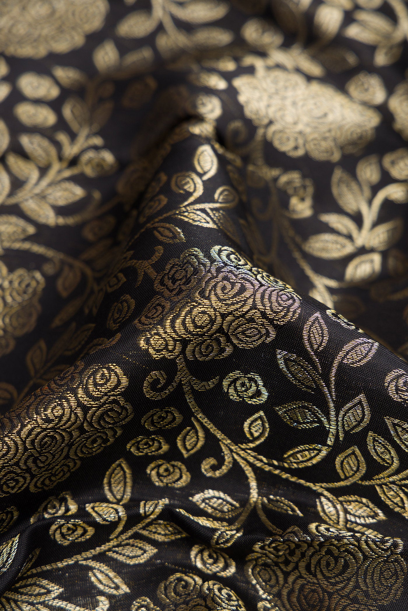 Close up of Black Dual Tone Kanchipuram Silk Saree with Zari Brocade on the body and Zari Border.  displaying folds