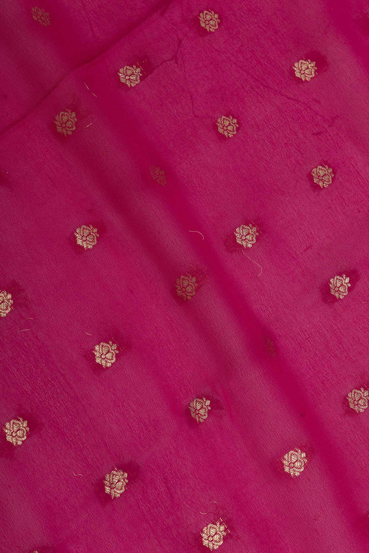 Close up of Pink Dual Tone Georgette Saree with Zari Butta on the body and Zari Border displaying folds
