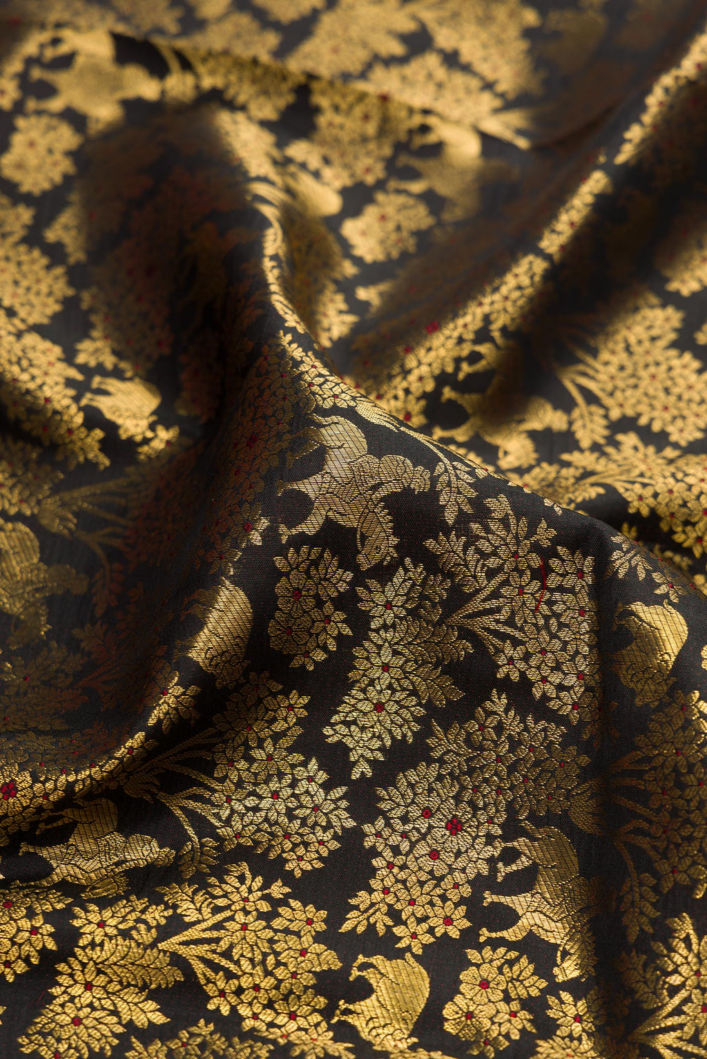 Close up of Black Kanchipuram Silk Saree with Zari Brocade on the body and Zari Border.  displaying folds