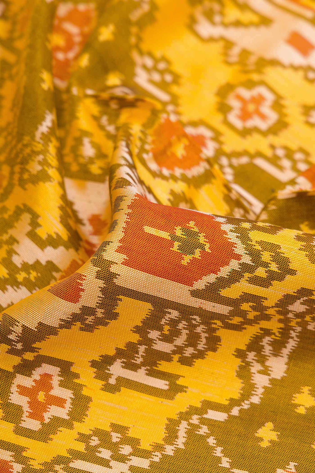 Close up of Mehandi Green Dual Tone Rajkot Patola Silk Saree with Ikat Print on the body and Ikat Border displaying folds