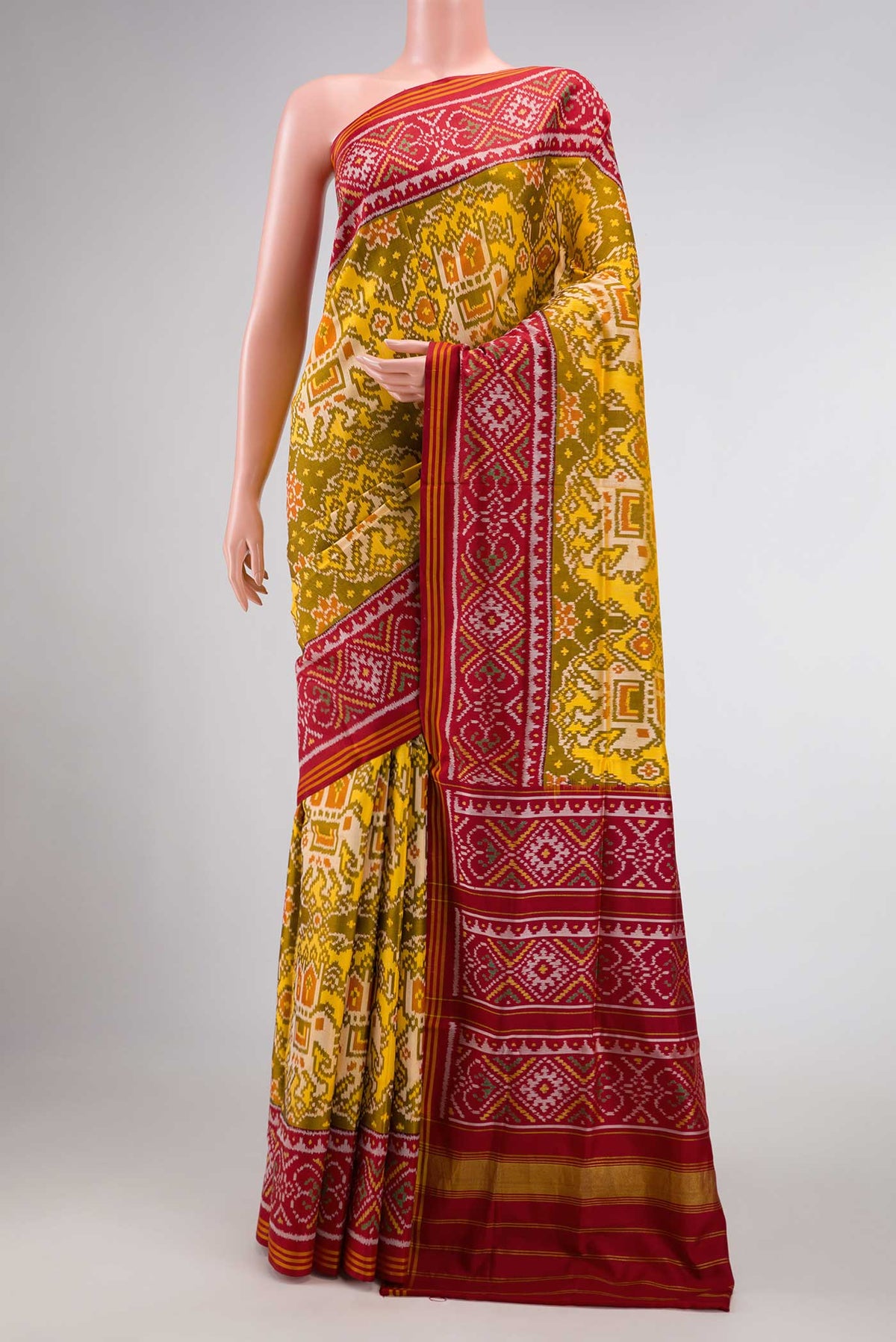 Mehandi Green Dual Tone Rajkot Patola Silk Saree with Ikat Print on the body and Ikat Border displayed on a mannequin