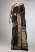 Black Dual Tone Kanchipuram Silk Saree with Checked design on the body and Zari Border displayed on a mannequin