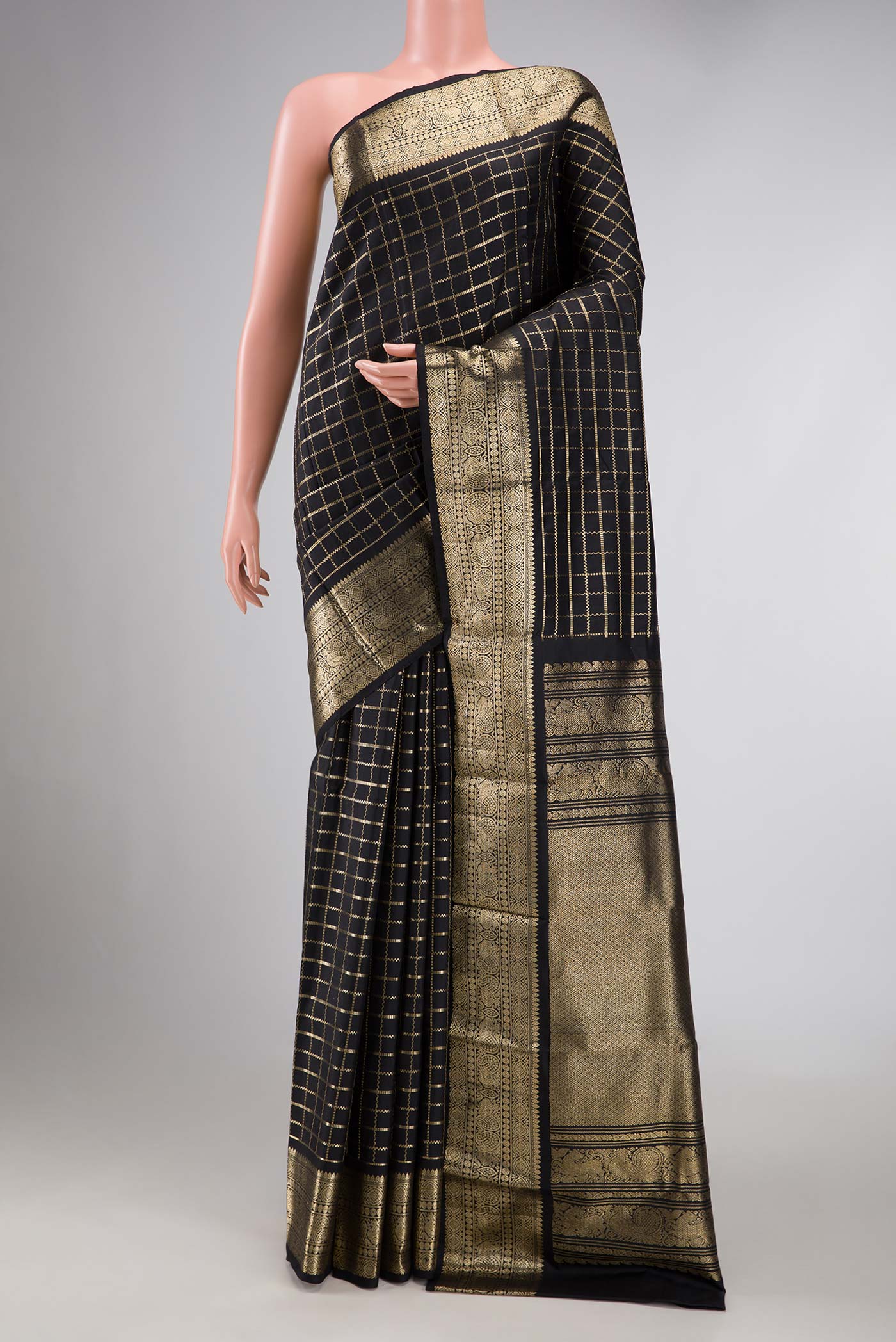 Black Dual Tone Kanchipuram Silk Saree with Checked design on the body and Zari Border displayed on a mannequin