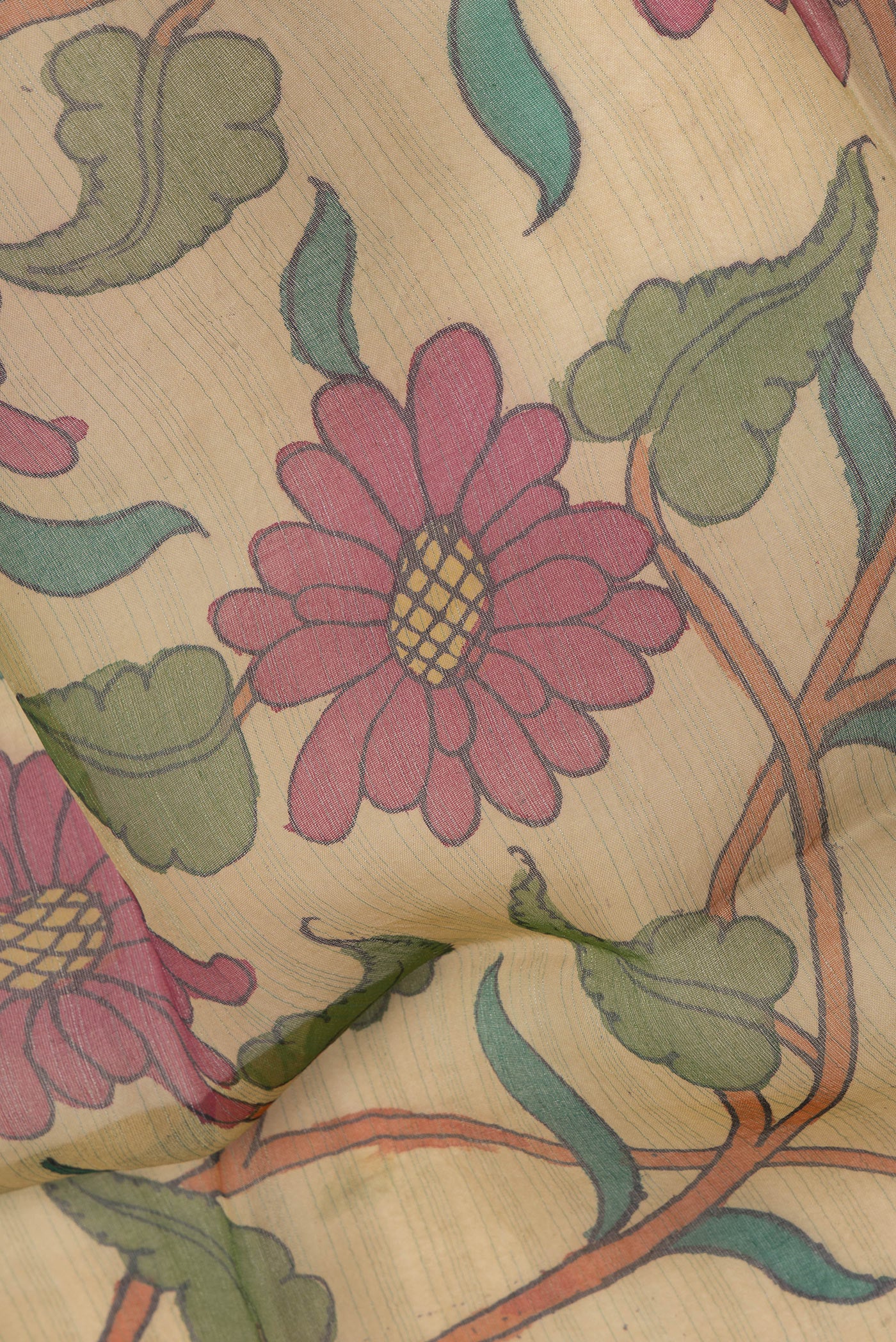 Close up of Beige Organza Silk Saree with kalamkari Print on the body and Thread Border.  displaying folds